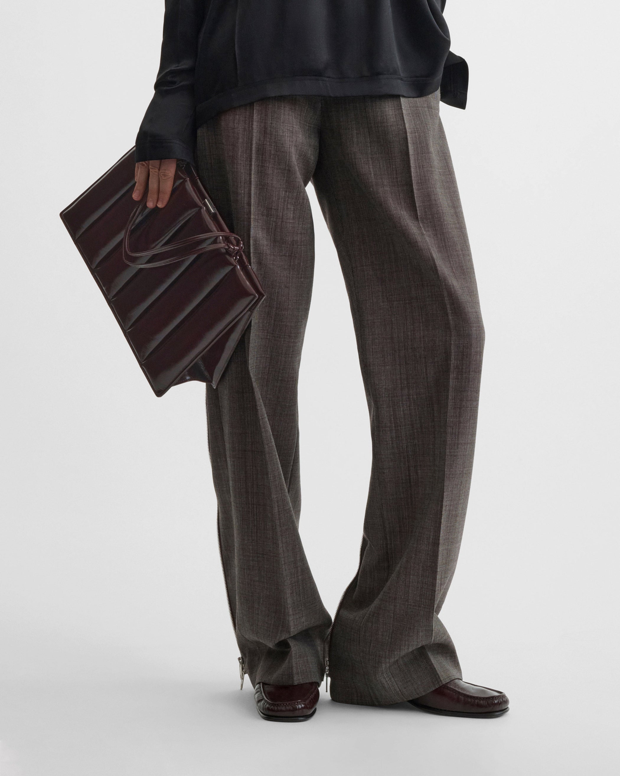 Model holding the Drive Bag in Oxblood leather