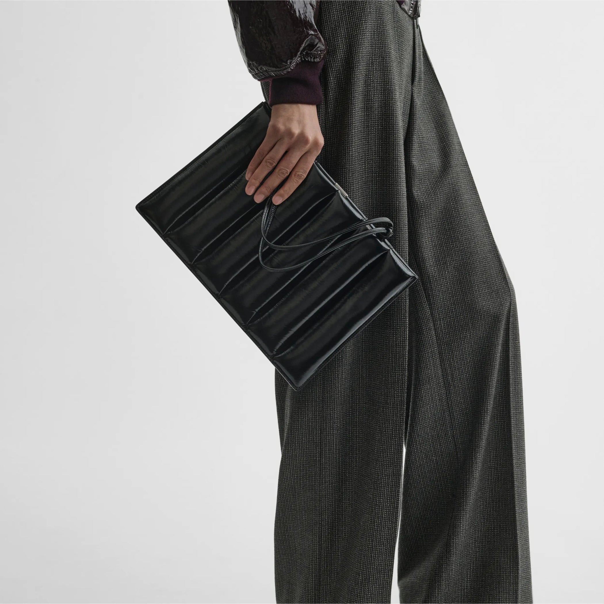 Front view of model holding drive bag in black leather.