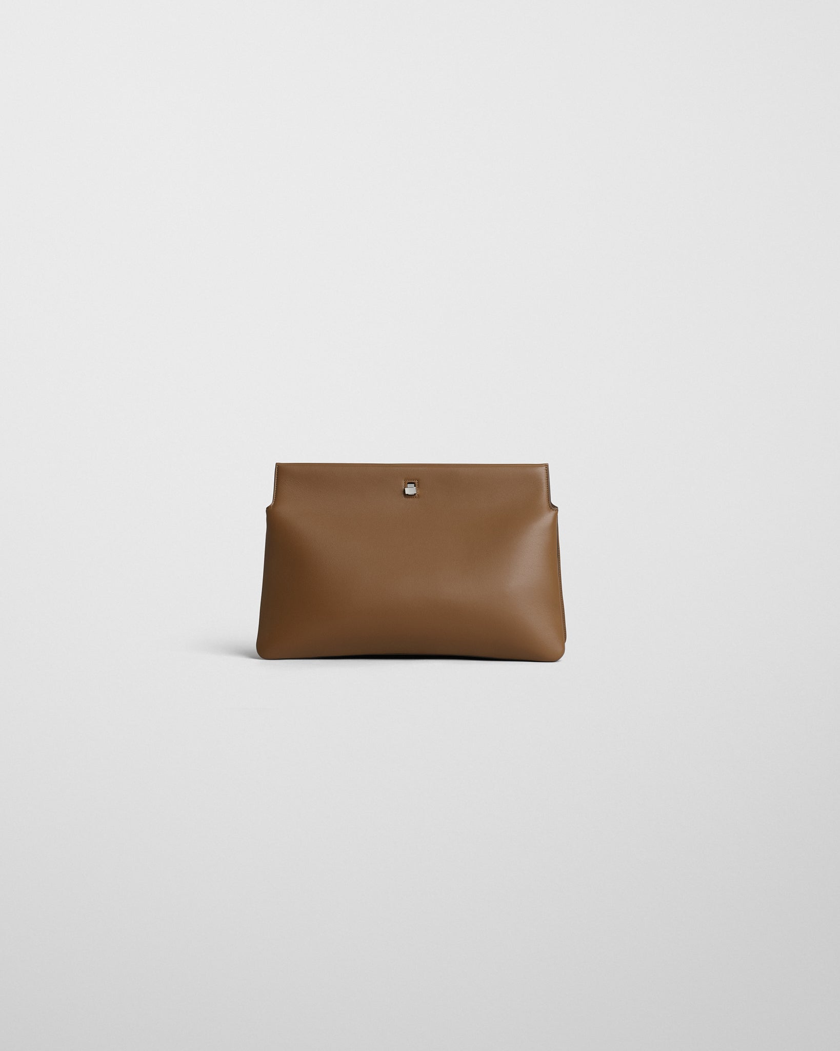 Front view of TRIPLEX CLUTCH in caramel leather.