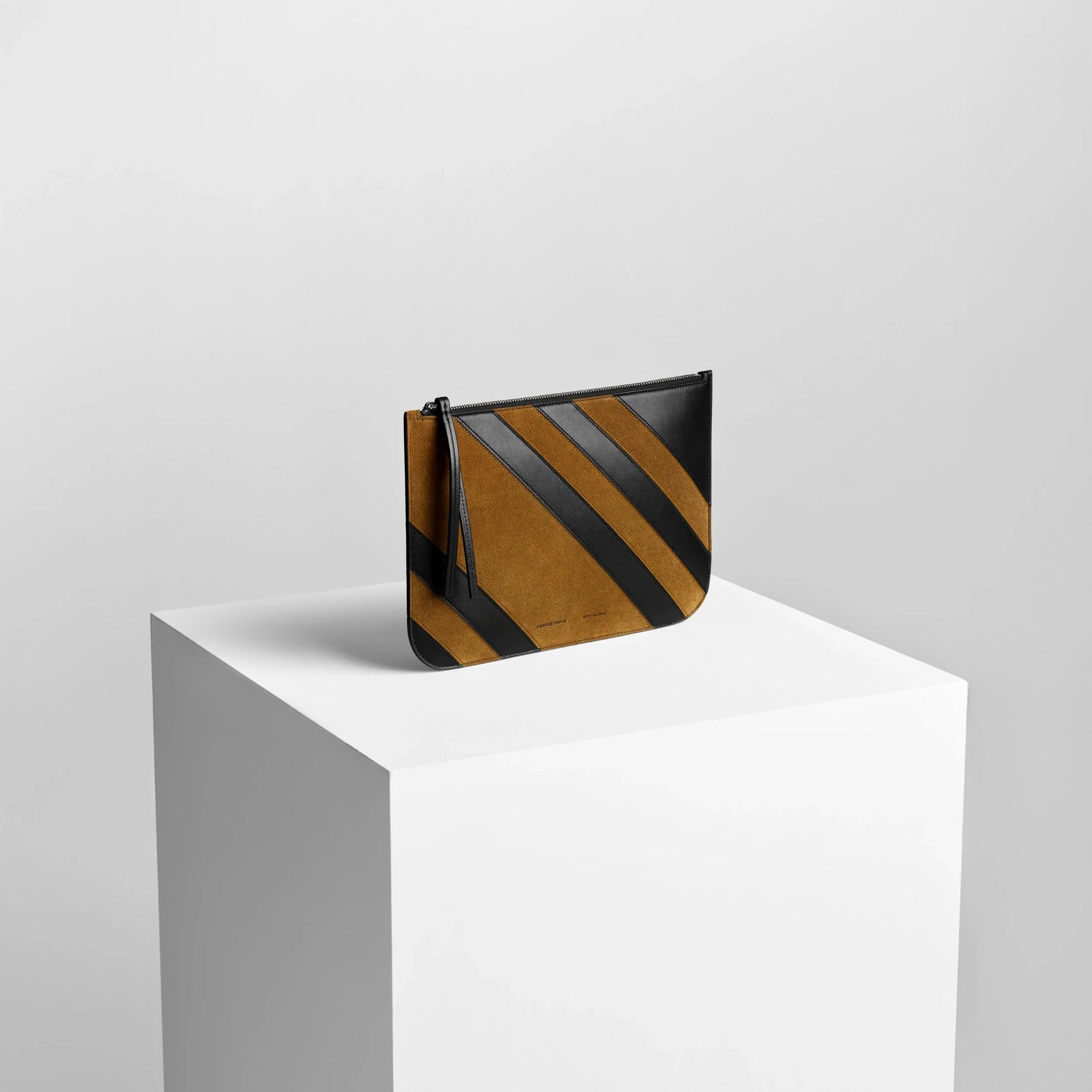Side view of pocket pouch in toffee/black leather.