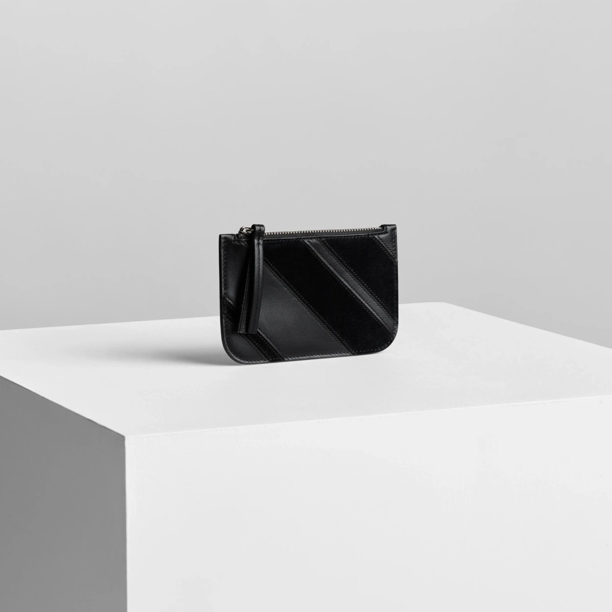 Side view of pocket card holder in black leather.