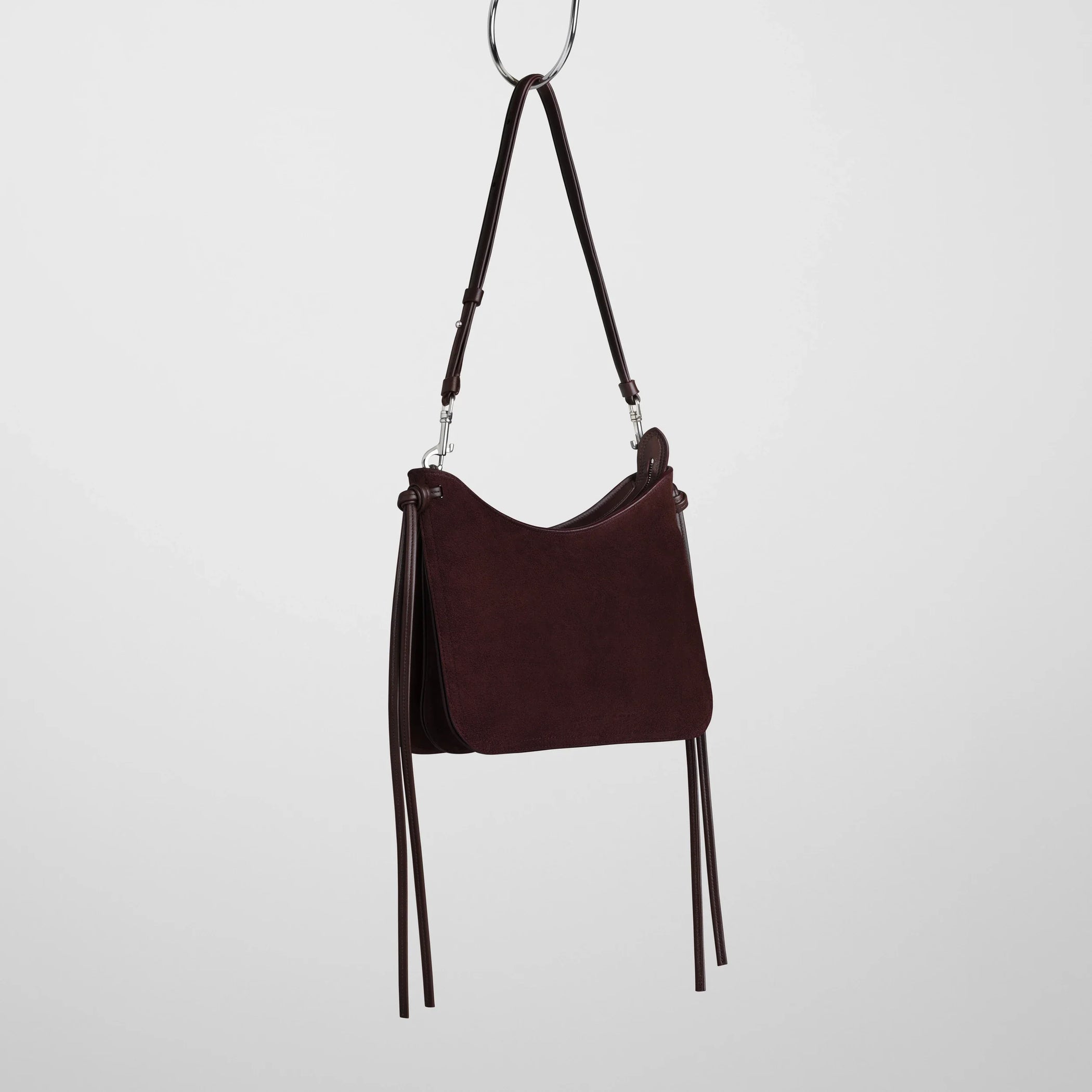 Side view of small gig bag in oxblood suede leather.