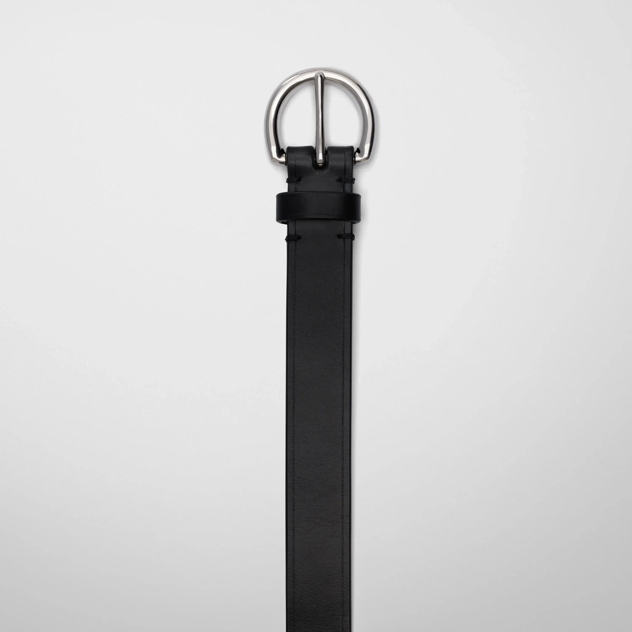 Detail view of round buckle belt in black