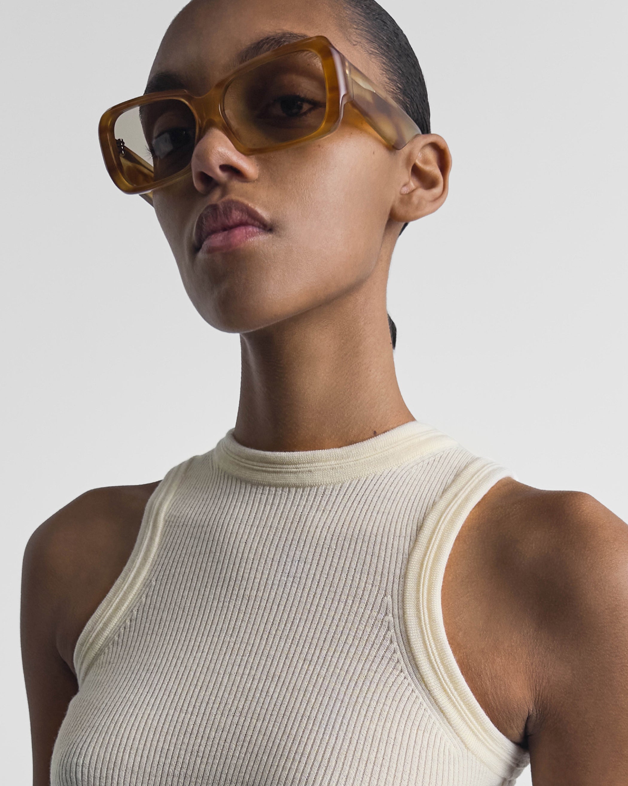 Close up view of model wearing SCORE SUNGLASSES in tortoiseshell acetate