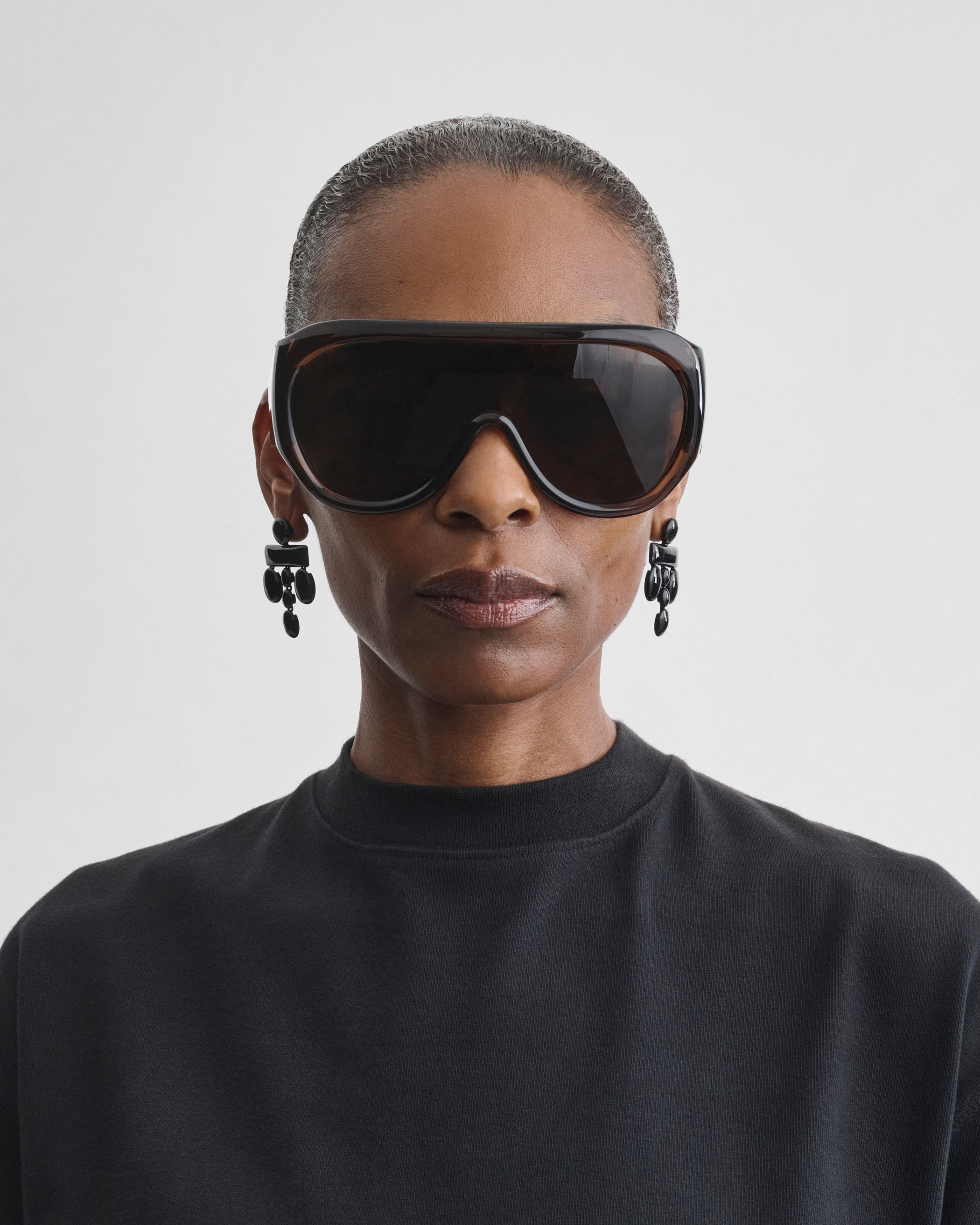 Front view of model wearing BOMBÉ SUNGLASSES in brown acetate