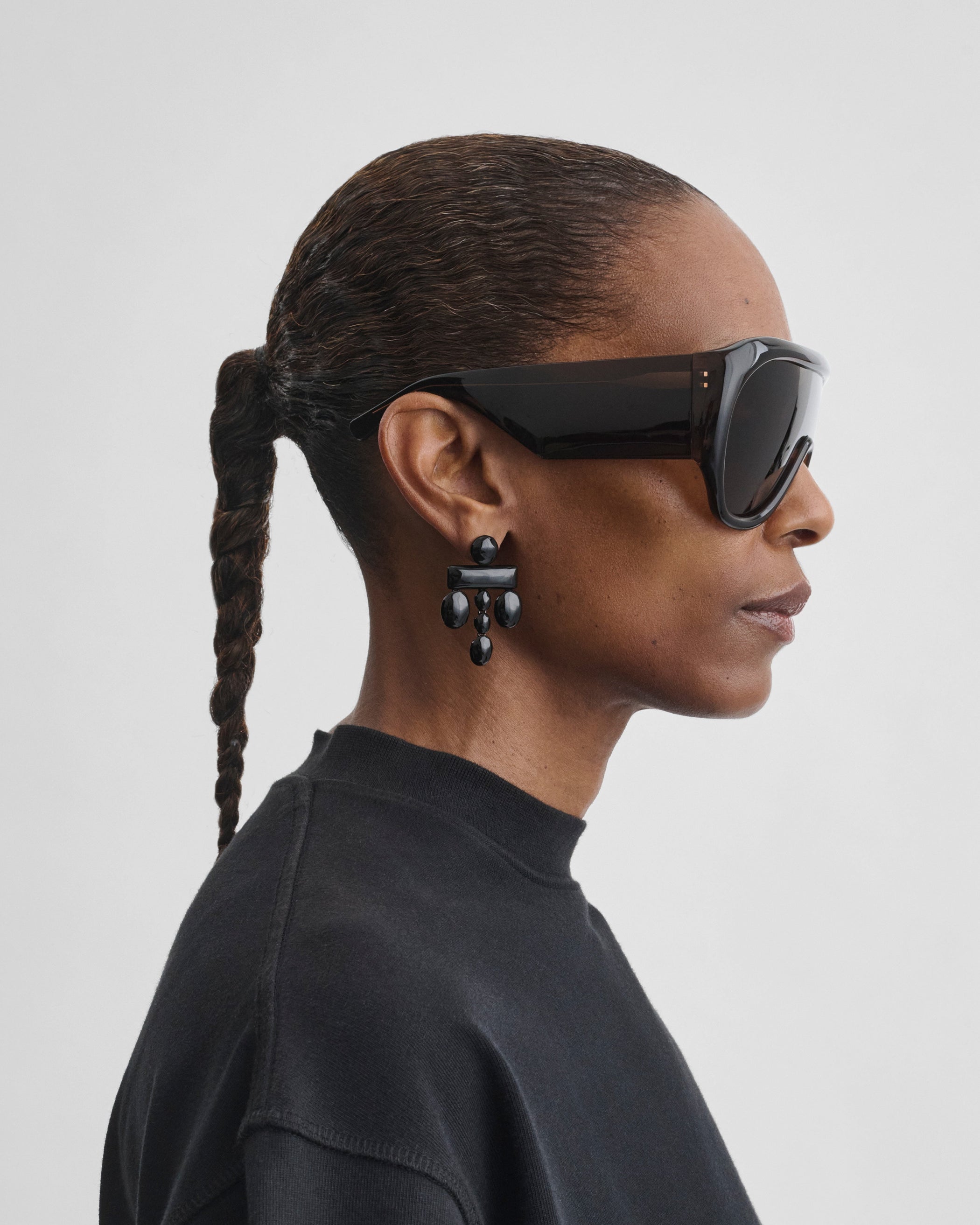 Side view of model wearing BOMBÉ SUNGLASSES in brown acetate