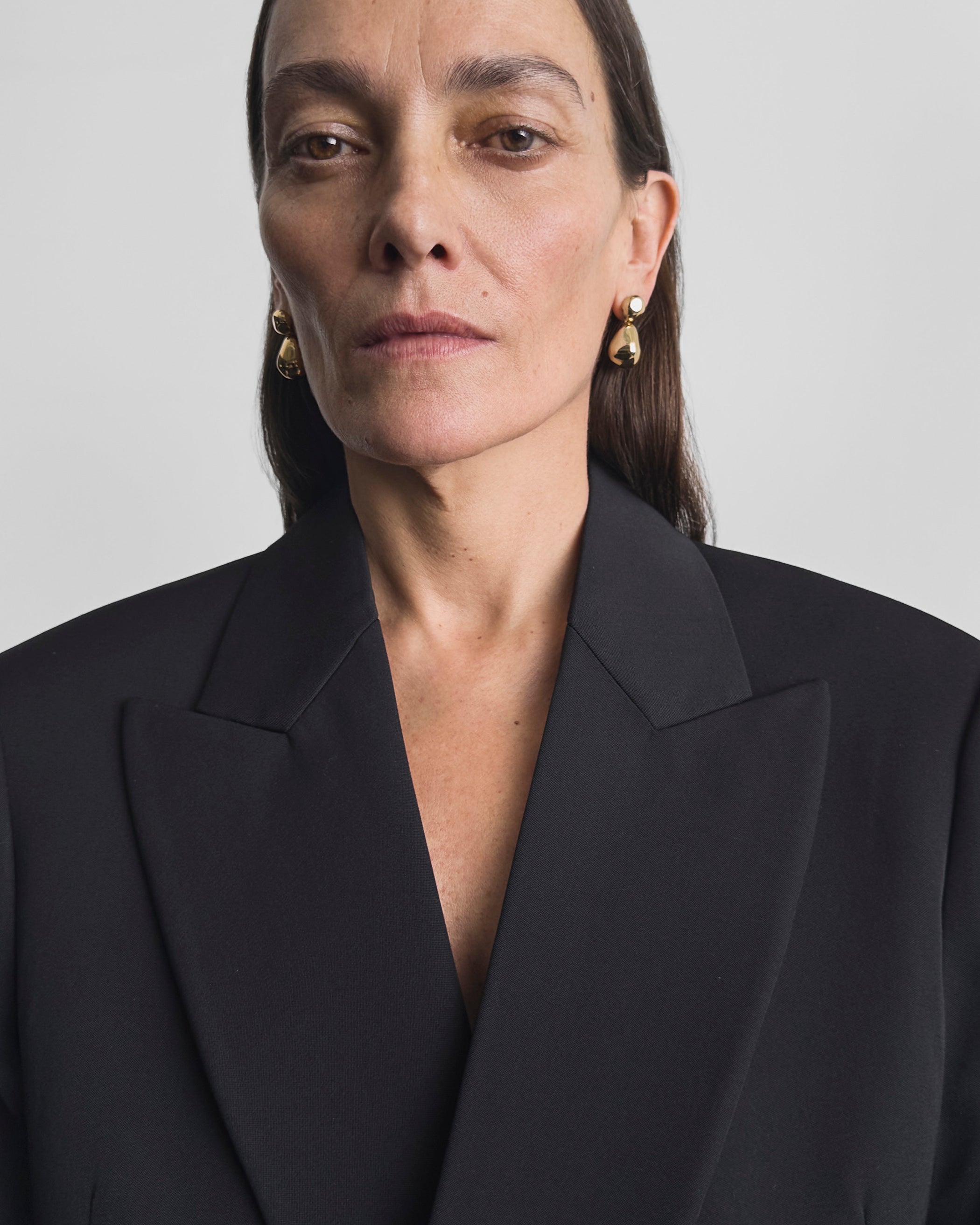 Model wearing DOUBLE BALL EARRINGS in gold plated sterling silver