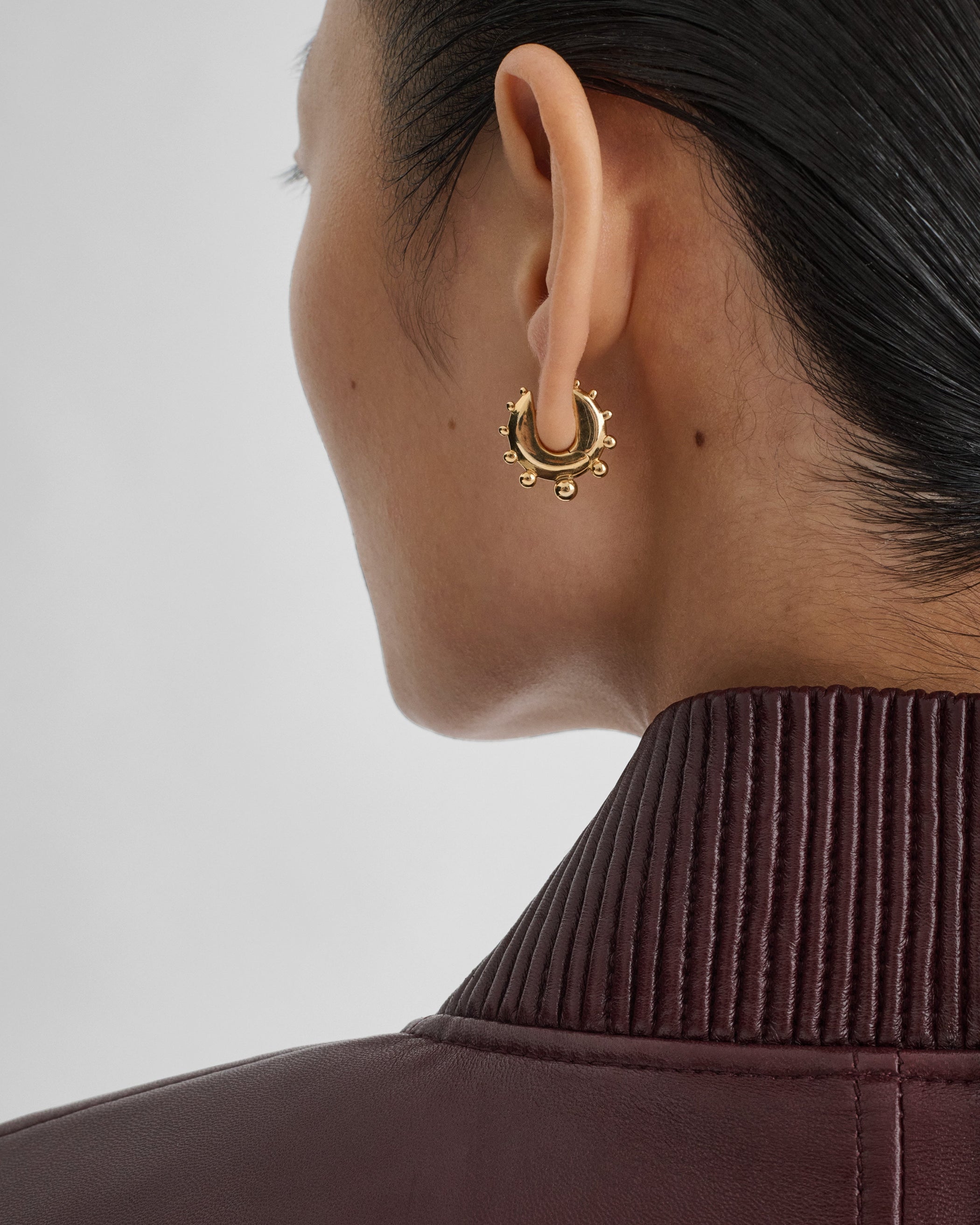 Model wearing BEADED HOOP EARRINGS SMALL in gold plated sterling silver