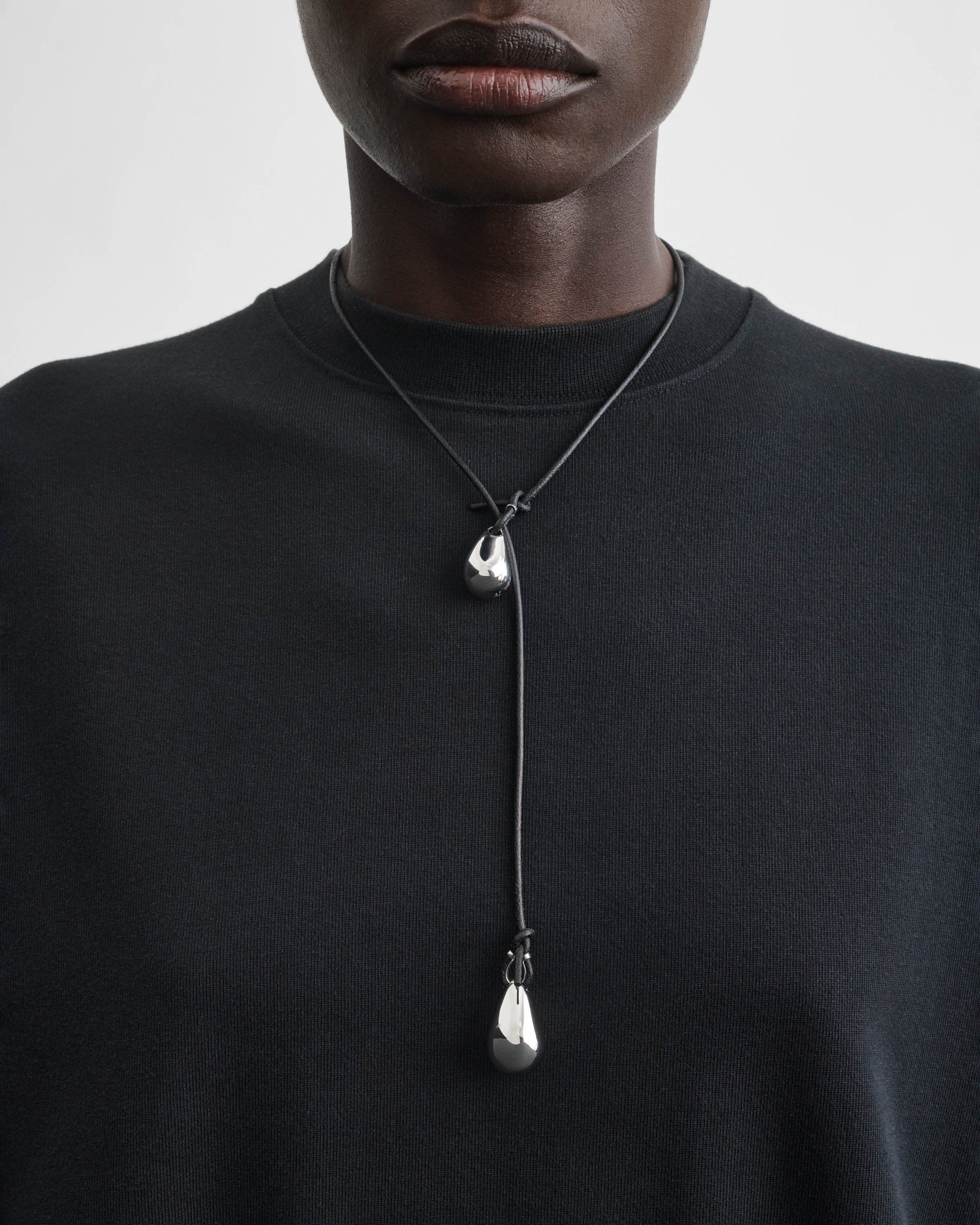 Model wearing PEBBLE DUO PENDANT in sterling silver