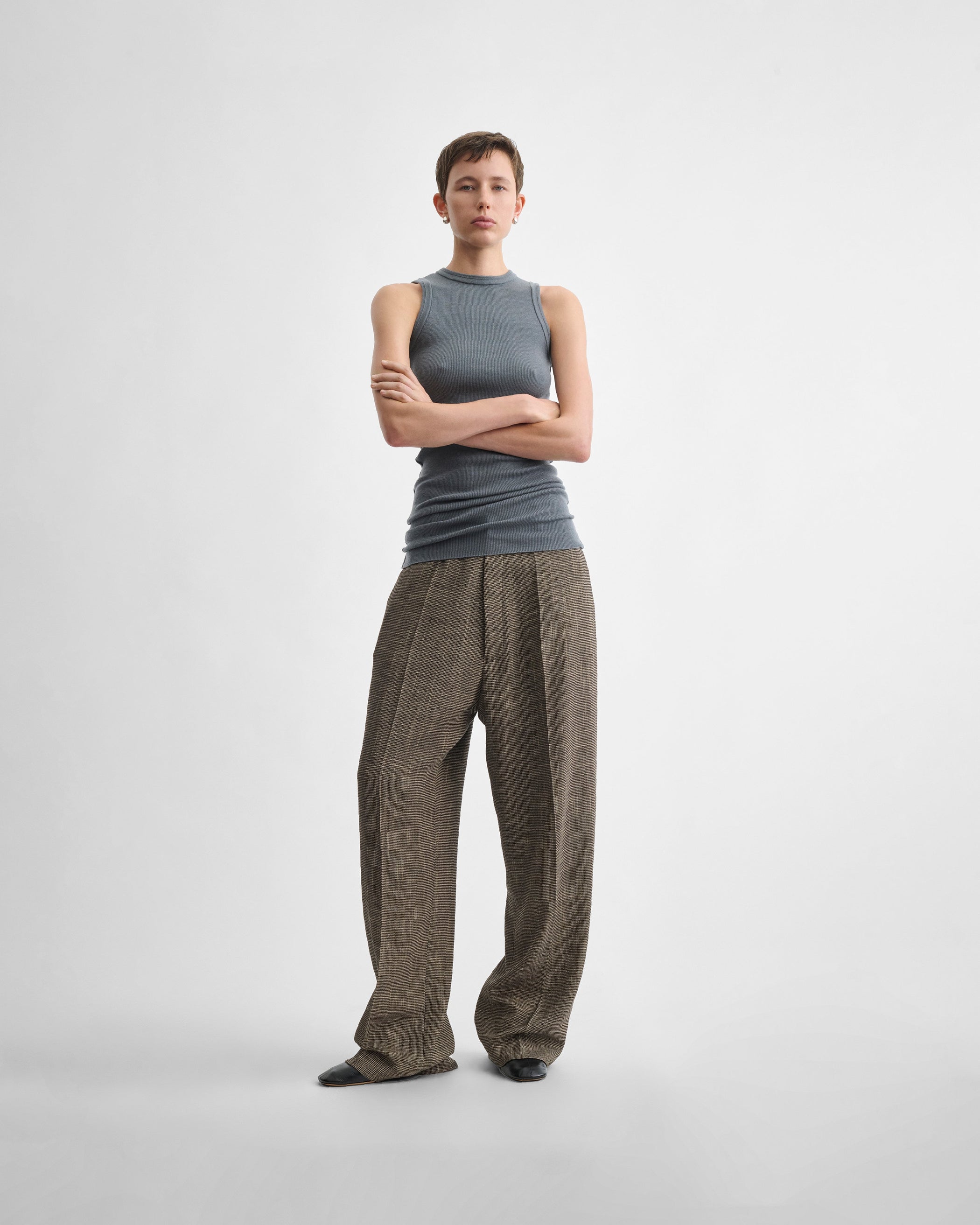 Full length front view of model wearing DROP TROUSERS in salt and pepper melange woven viscose