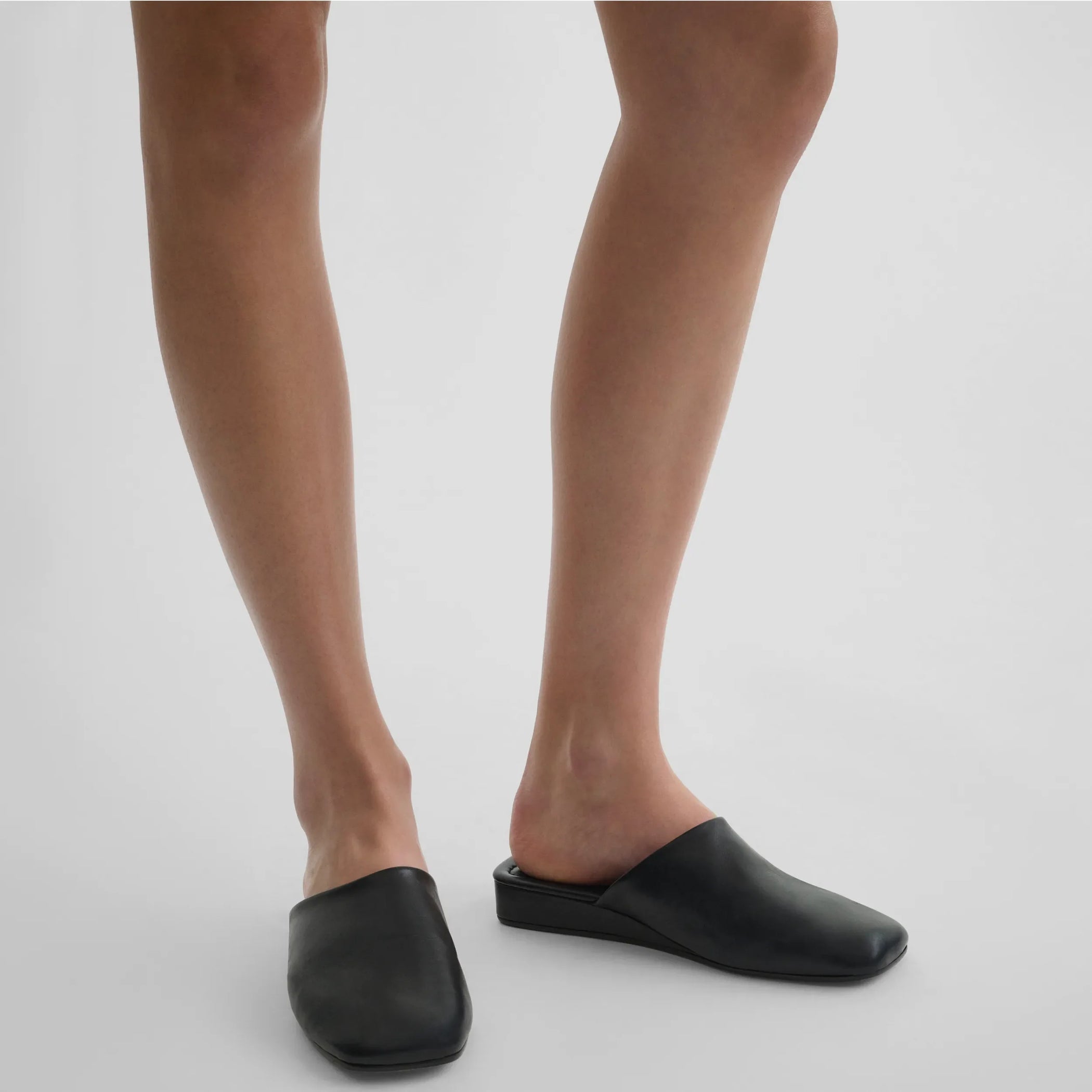 Front view of model wearing robe slide in black leather.