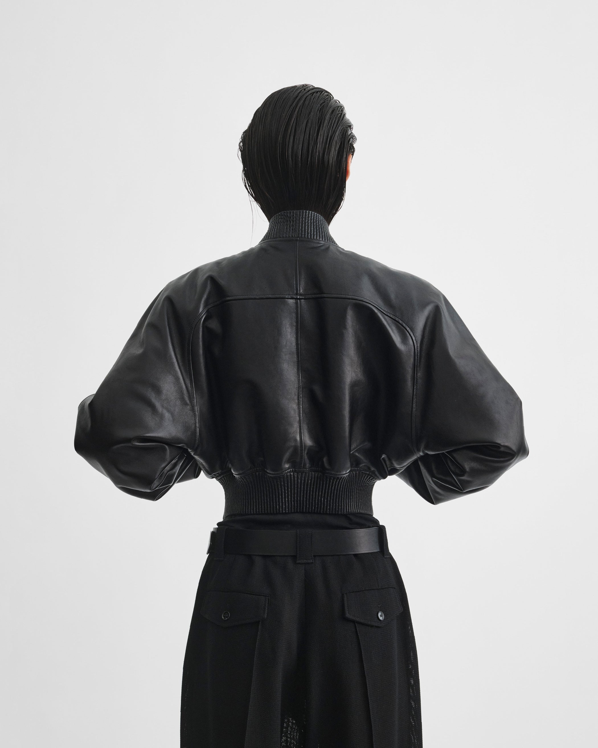 Back view of model wearing SHRUNK BOMBER in black leather