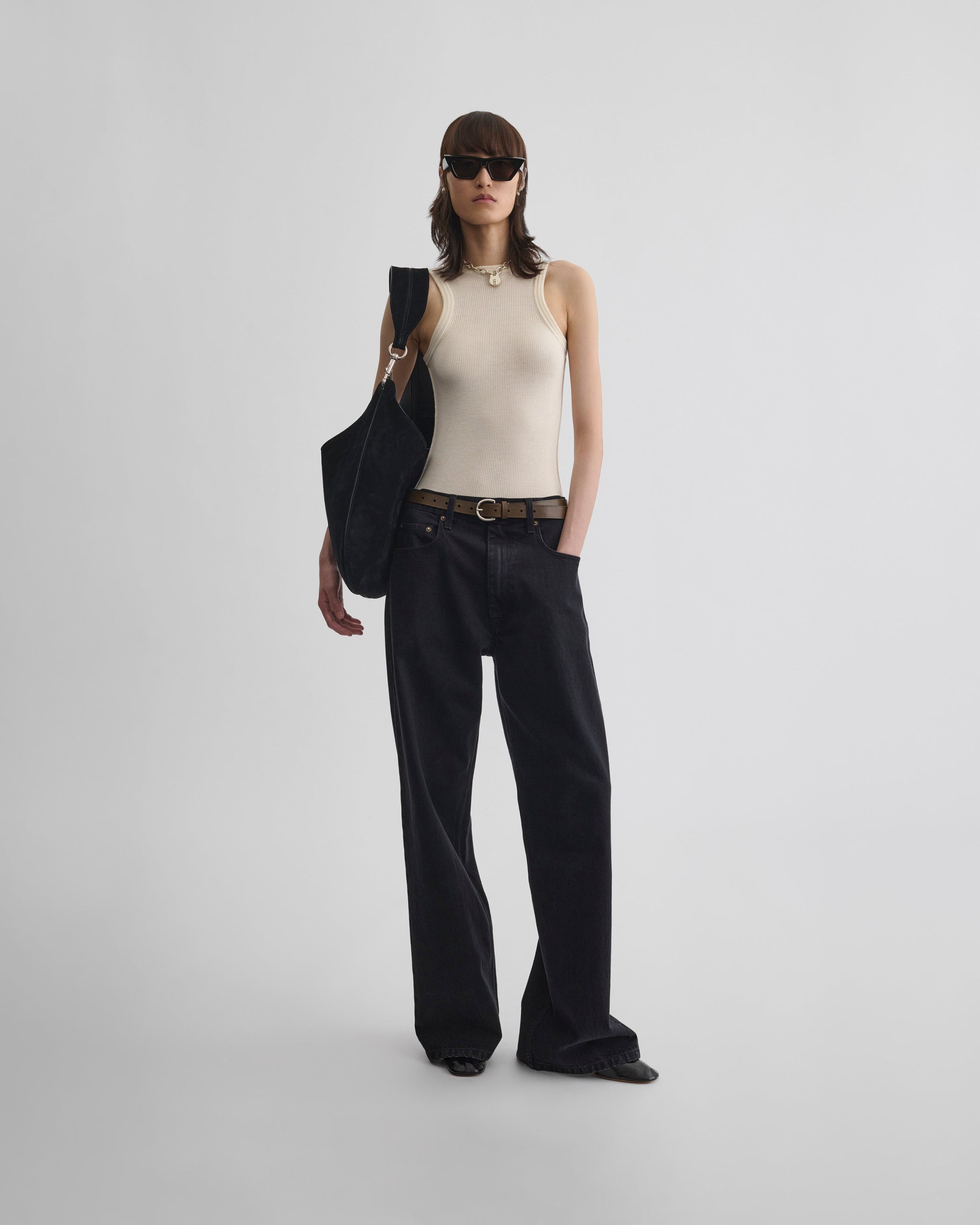 Full length front view of model wearing ZIP JEANS in black cotton