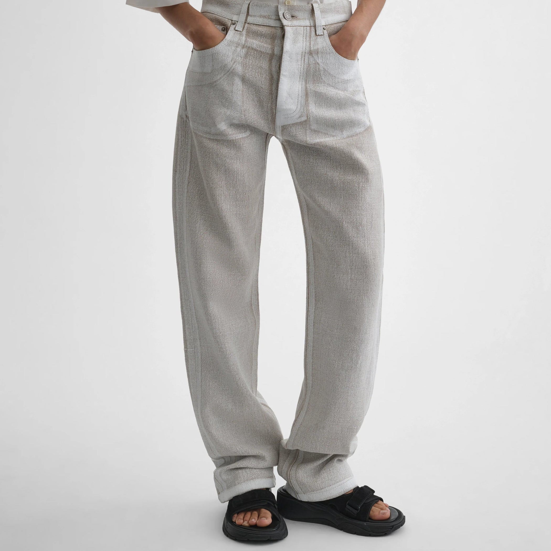 Front close up view of model wearing the classic jeans in hay