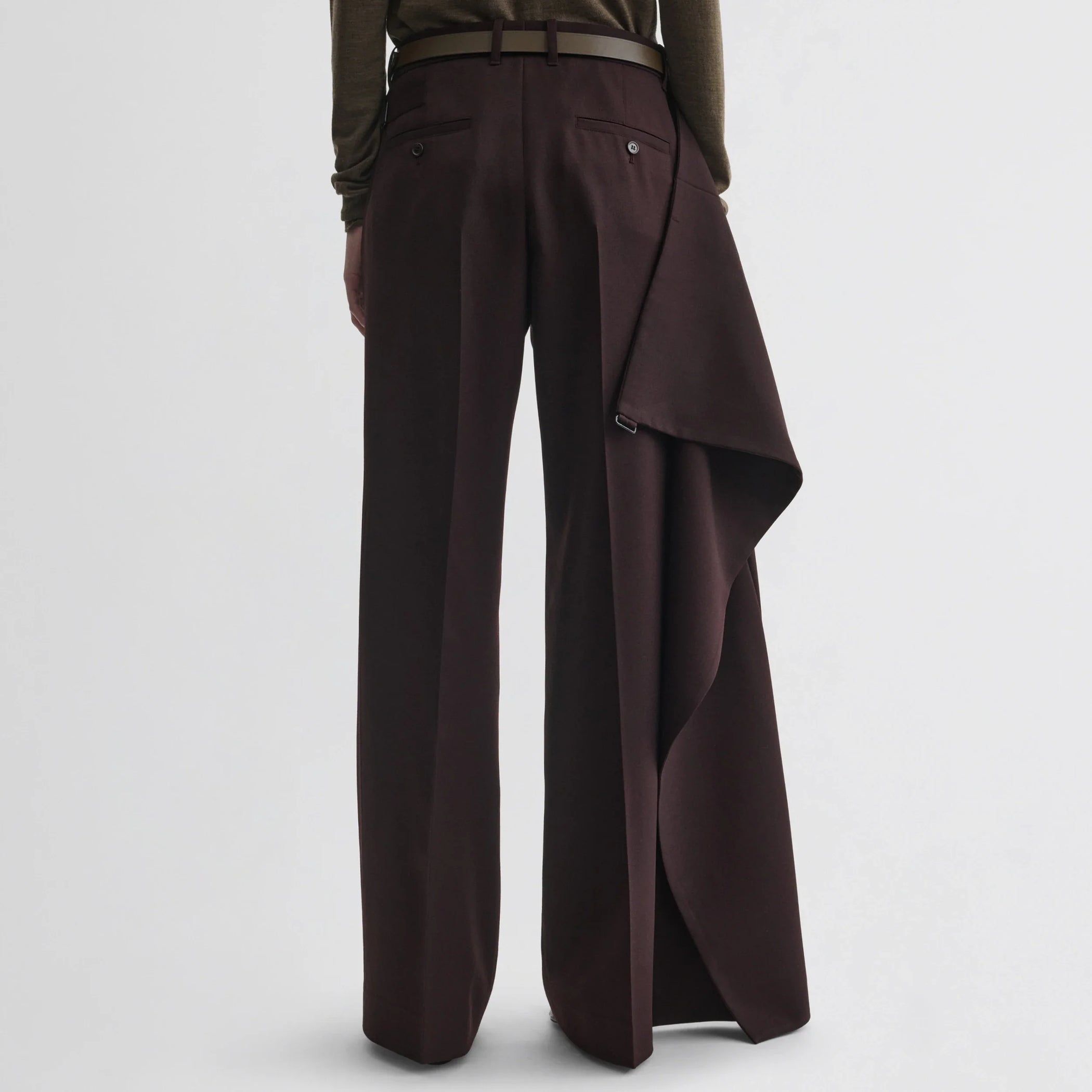 Back view of model wearing apron trousers in chocolate wool.