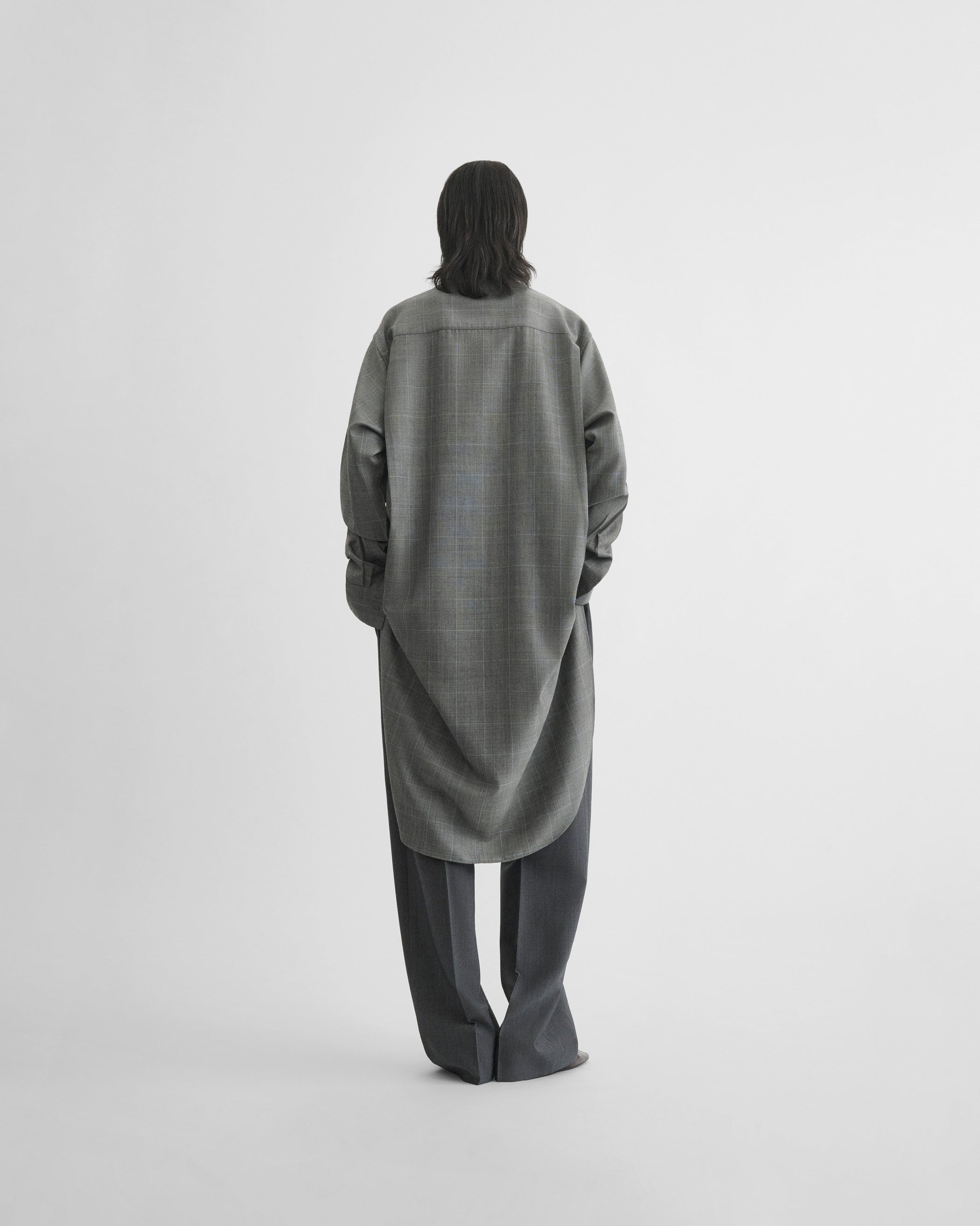 View of elongated shirt in black-blue wool