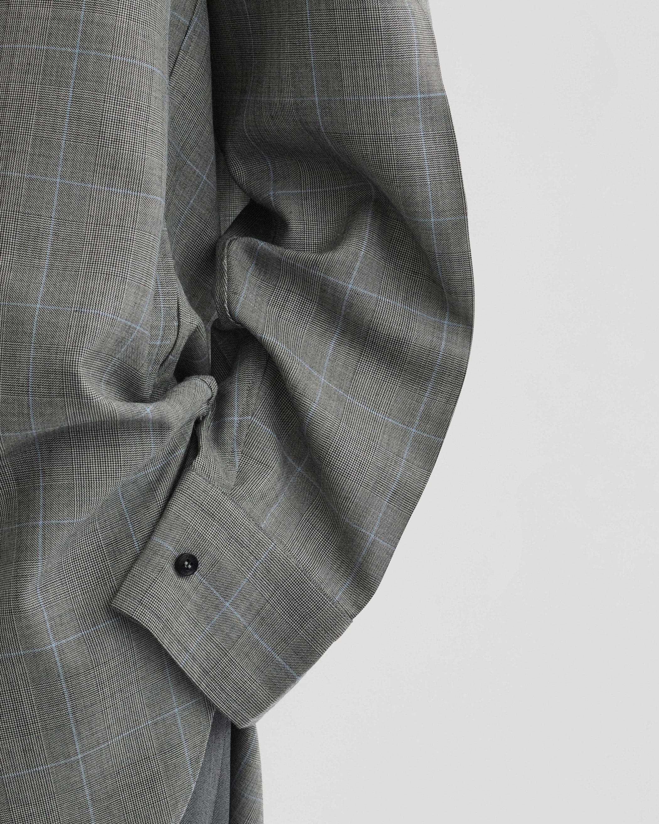 View of elongated shirt in black-blue wool