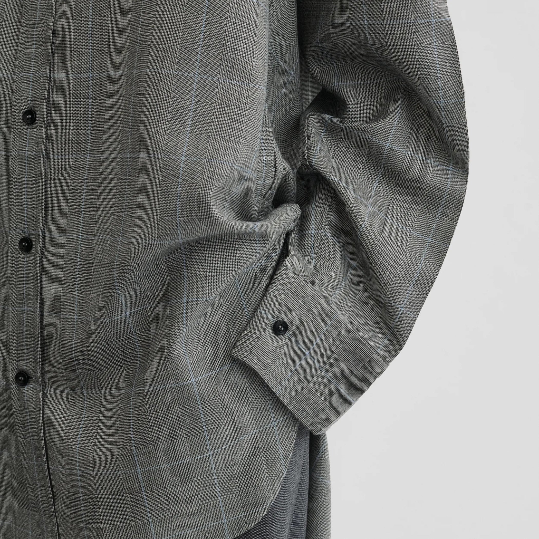 Close up detail view of elongated shirt in black-blue wool