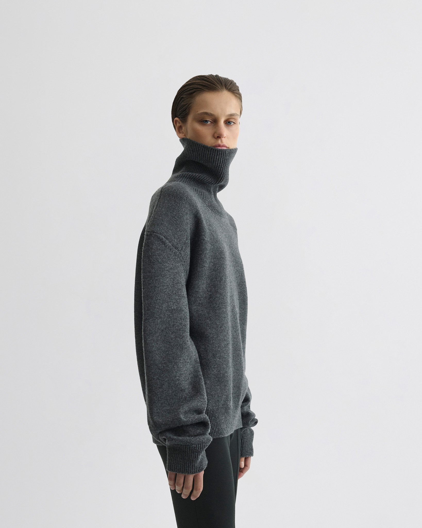 Side view of model wearing Patch Shoulder Jumper in grey melange wool cashmere