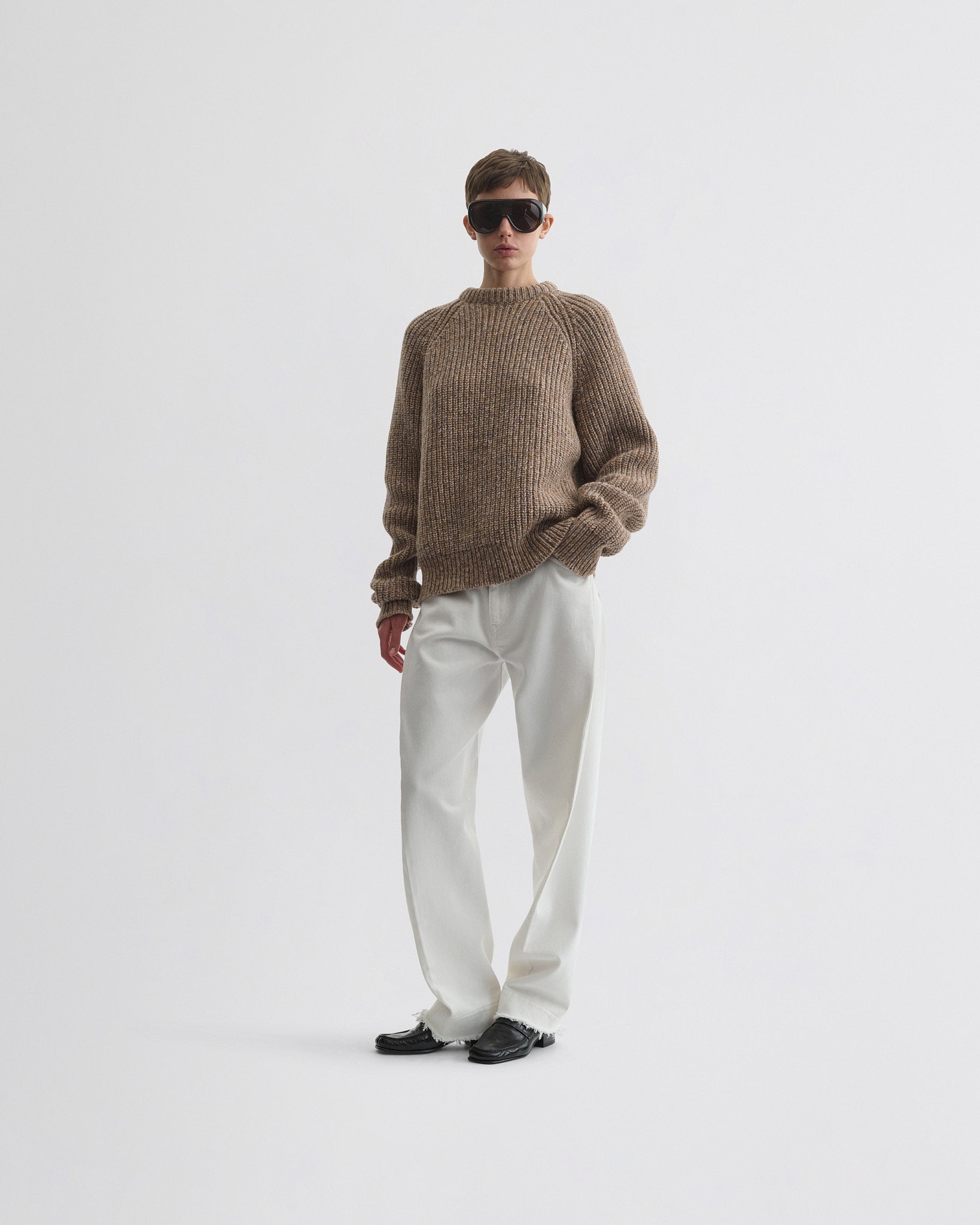 Front view of model wearing mouline jumper in camel wool.