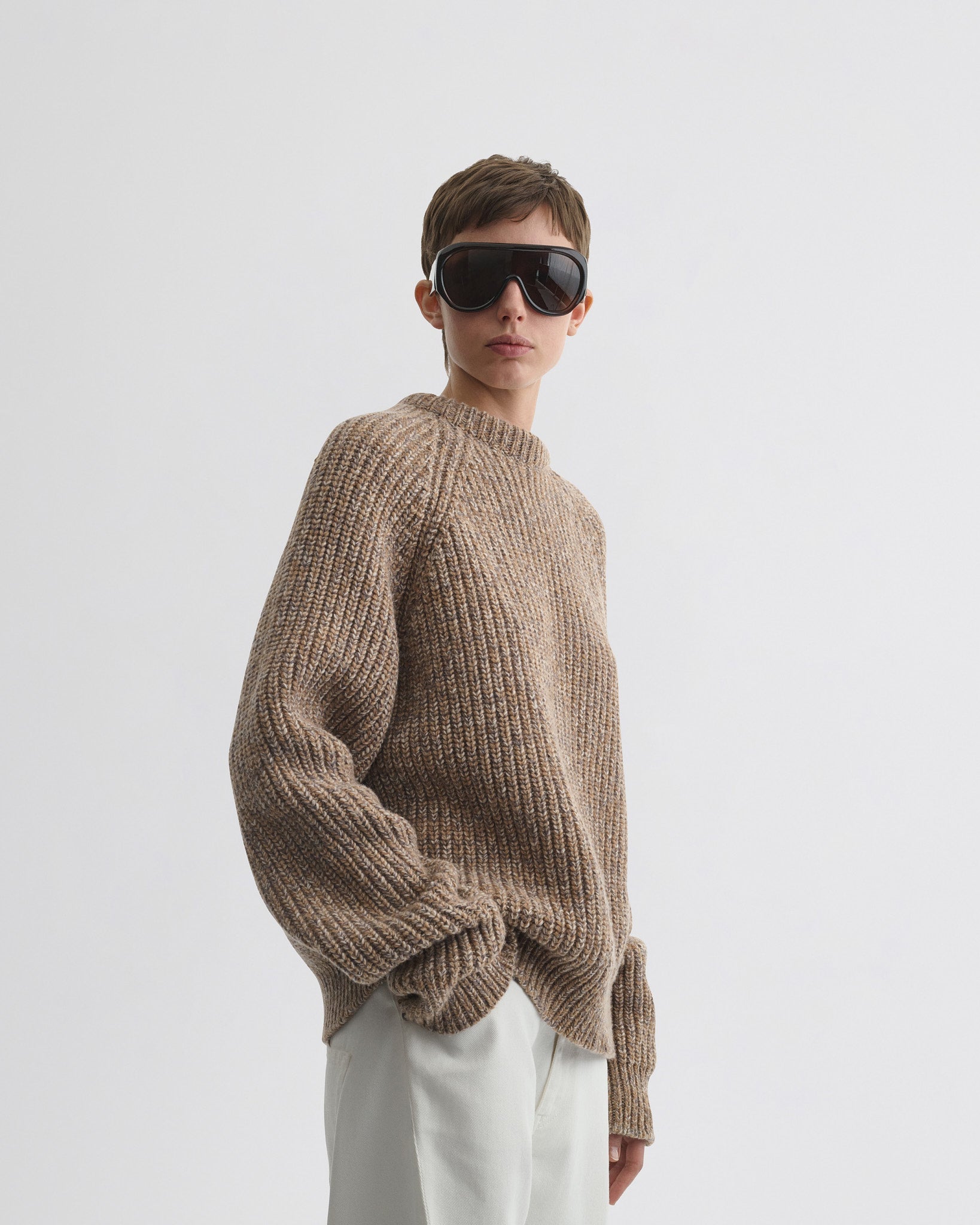 Front view of model wearing mouline jumper in camel wool.