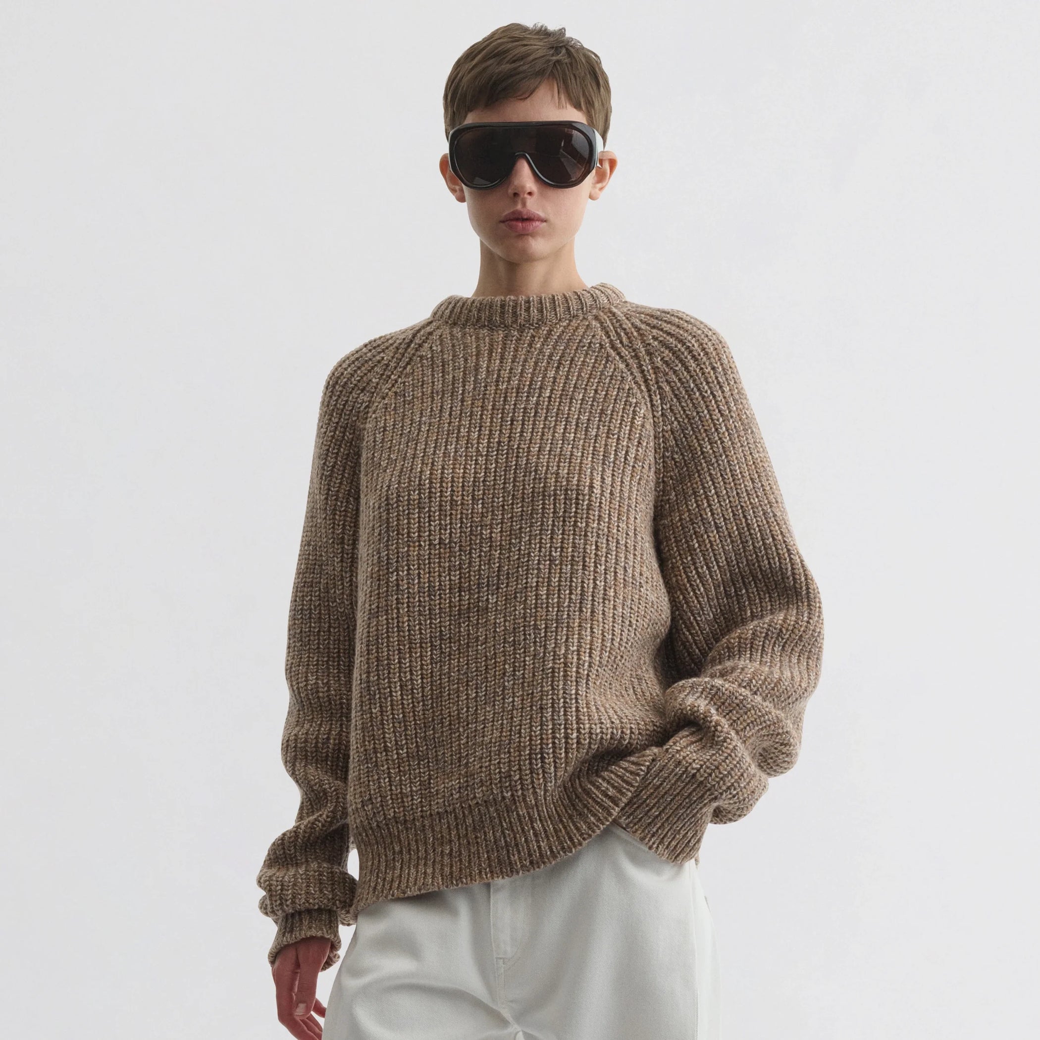 Front view of model wearing mouline jumper in camel wool.