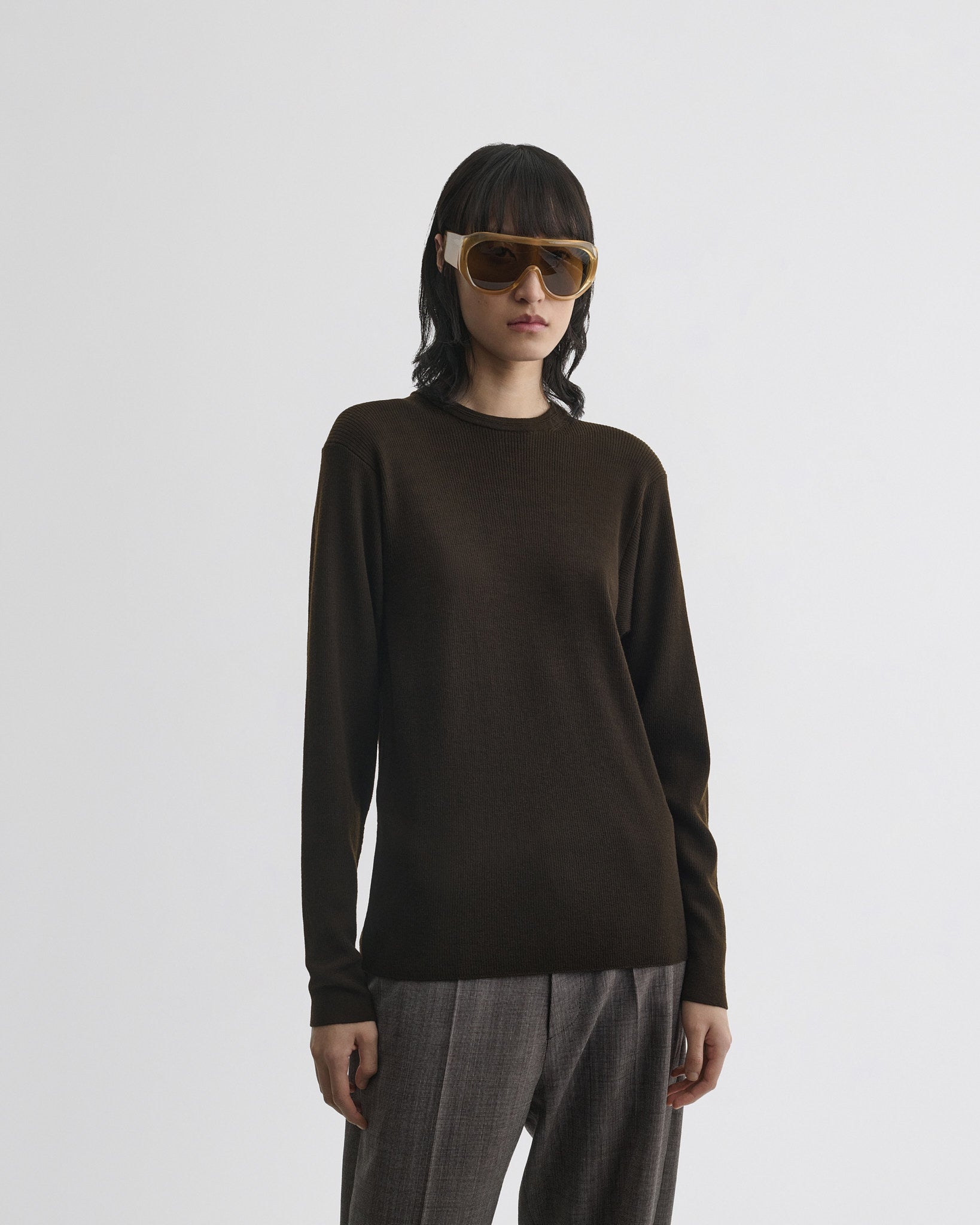 Front view of model wearing batwing crewneck in dark khaki wool.