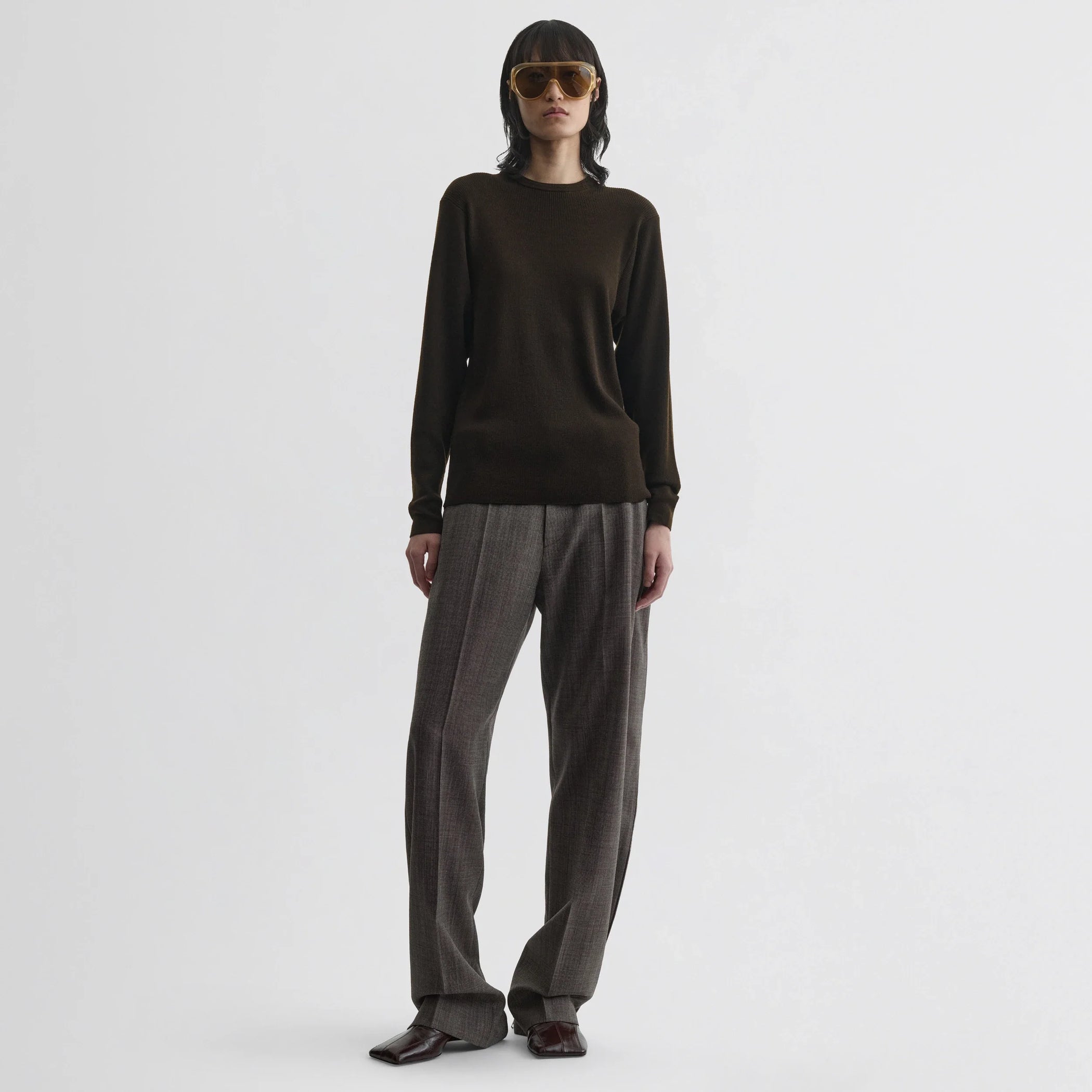 Front view of model wearing batwing crewneck in dark khaki wool.