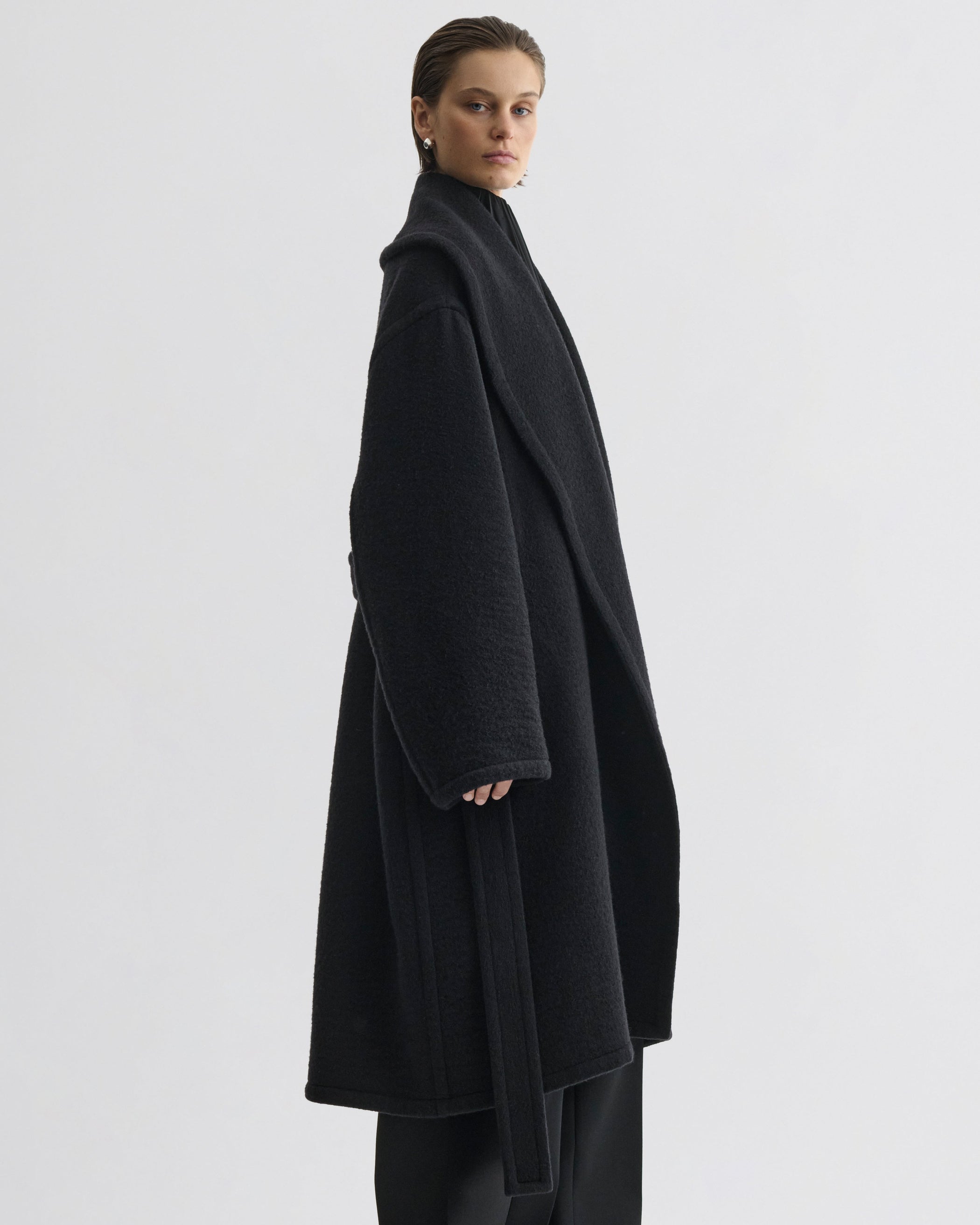 Side view of model wearing ROBE COAT in black cashmere