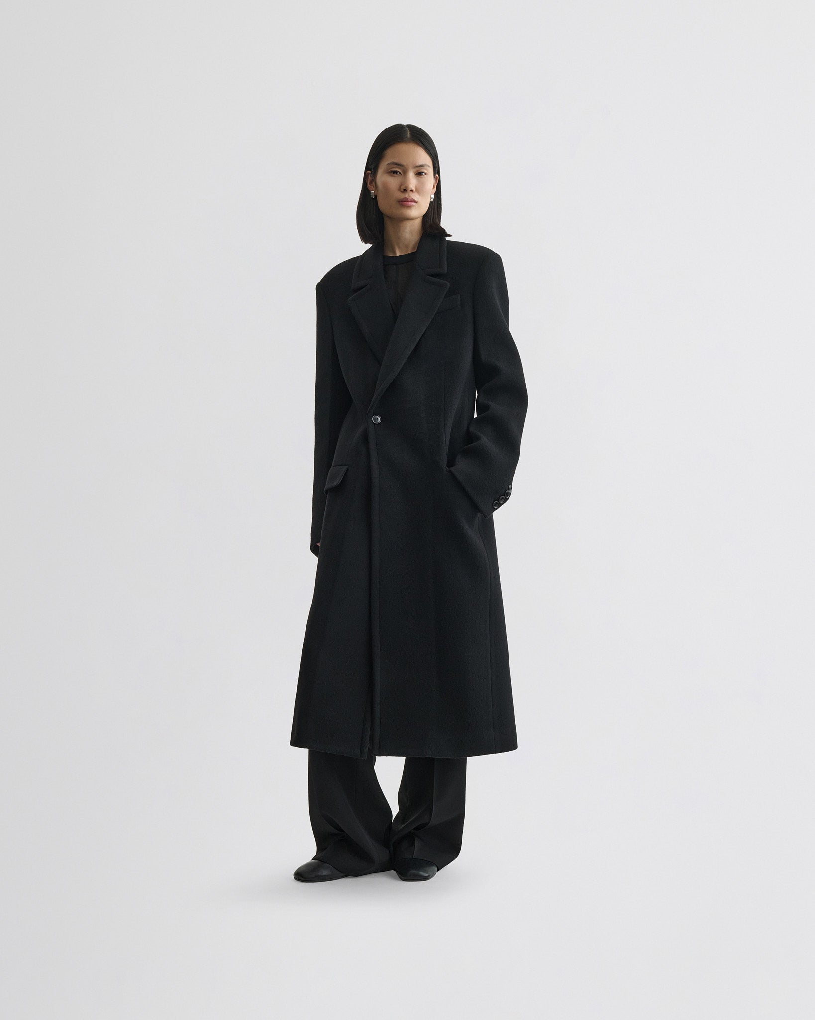 Front view of model wearing classic coat in black cashmere
