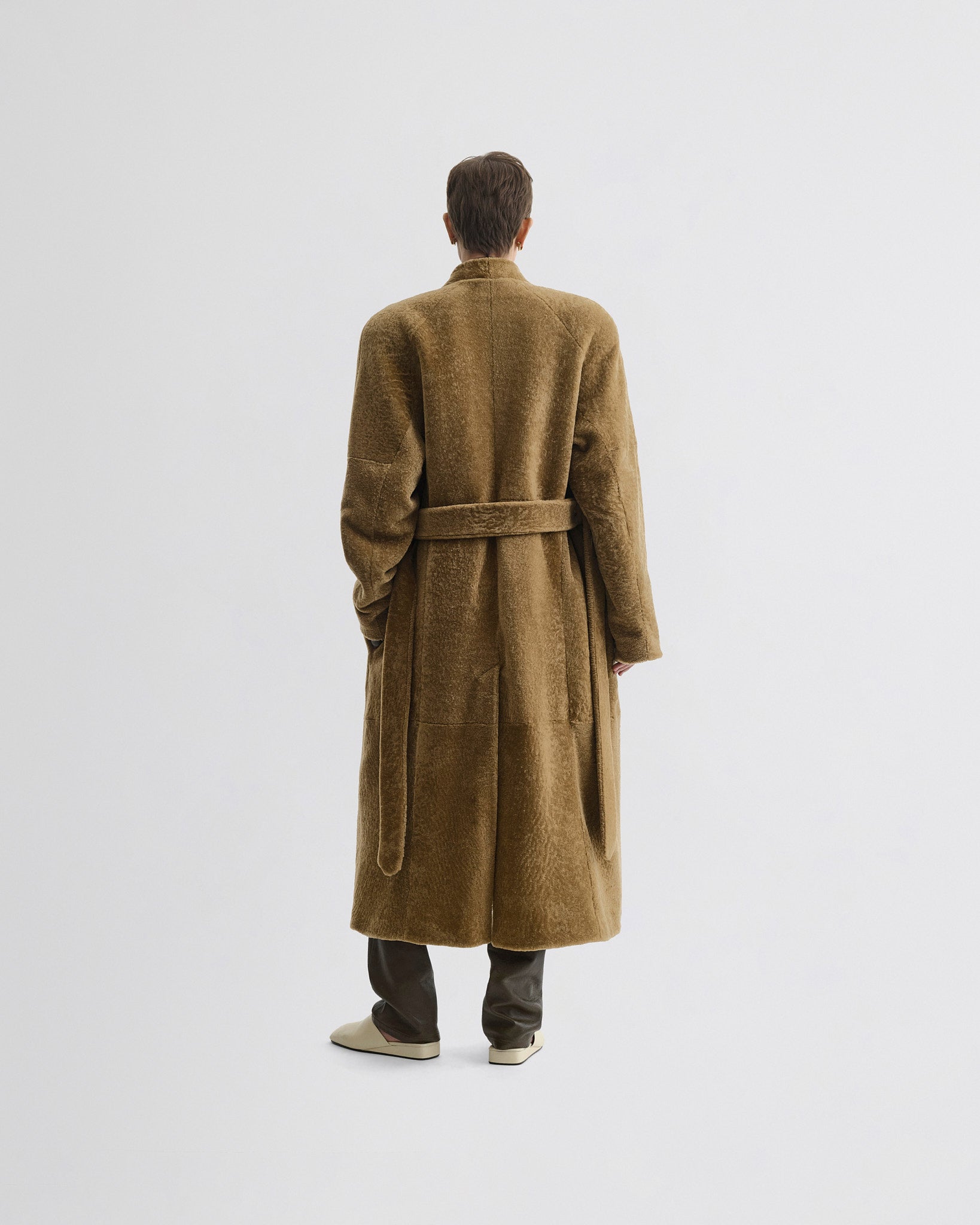 Back view of model wearing Shaved Robe Coat in tabac shearling