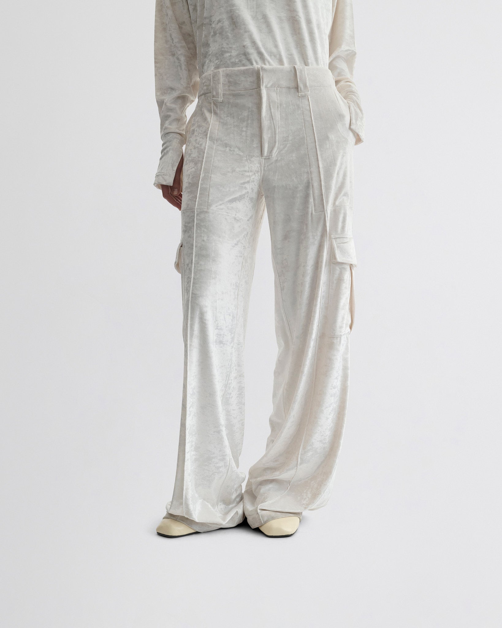 View of liquid cargo trousers in white crushed velvet