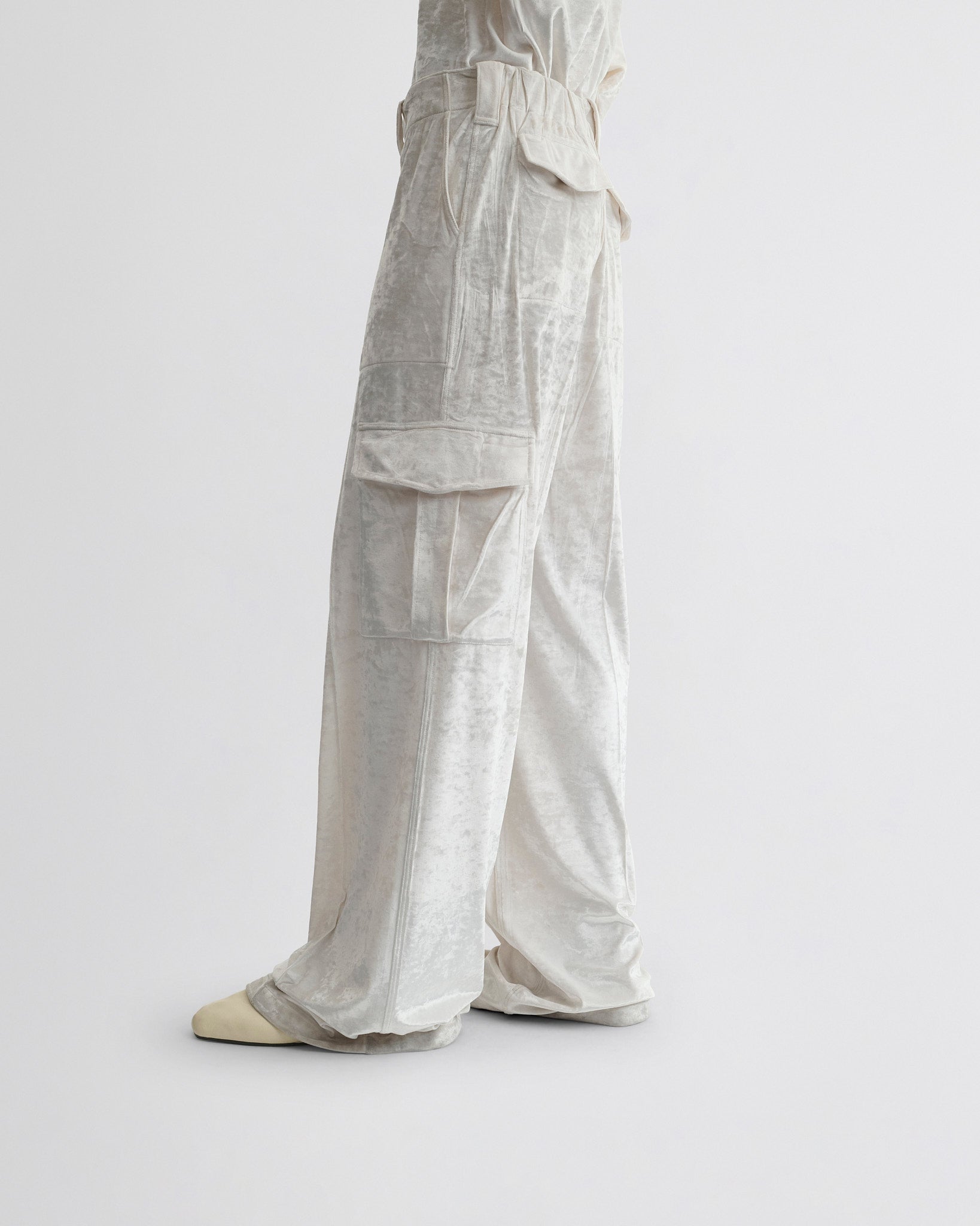 View of liquid cargo trousers in white crushed velvet