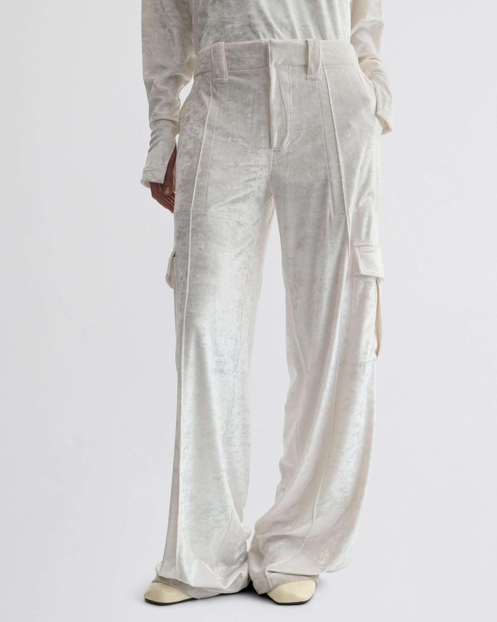Front view of model wearing LIQUID CARGO TROUSERS  in white crushed velvet