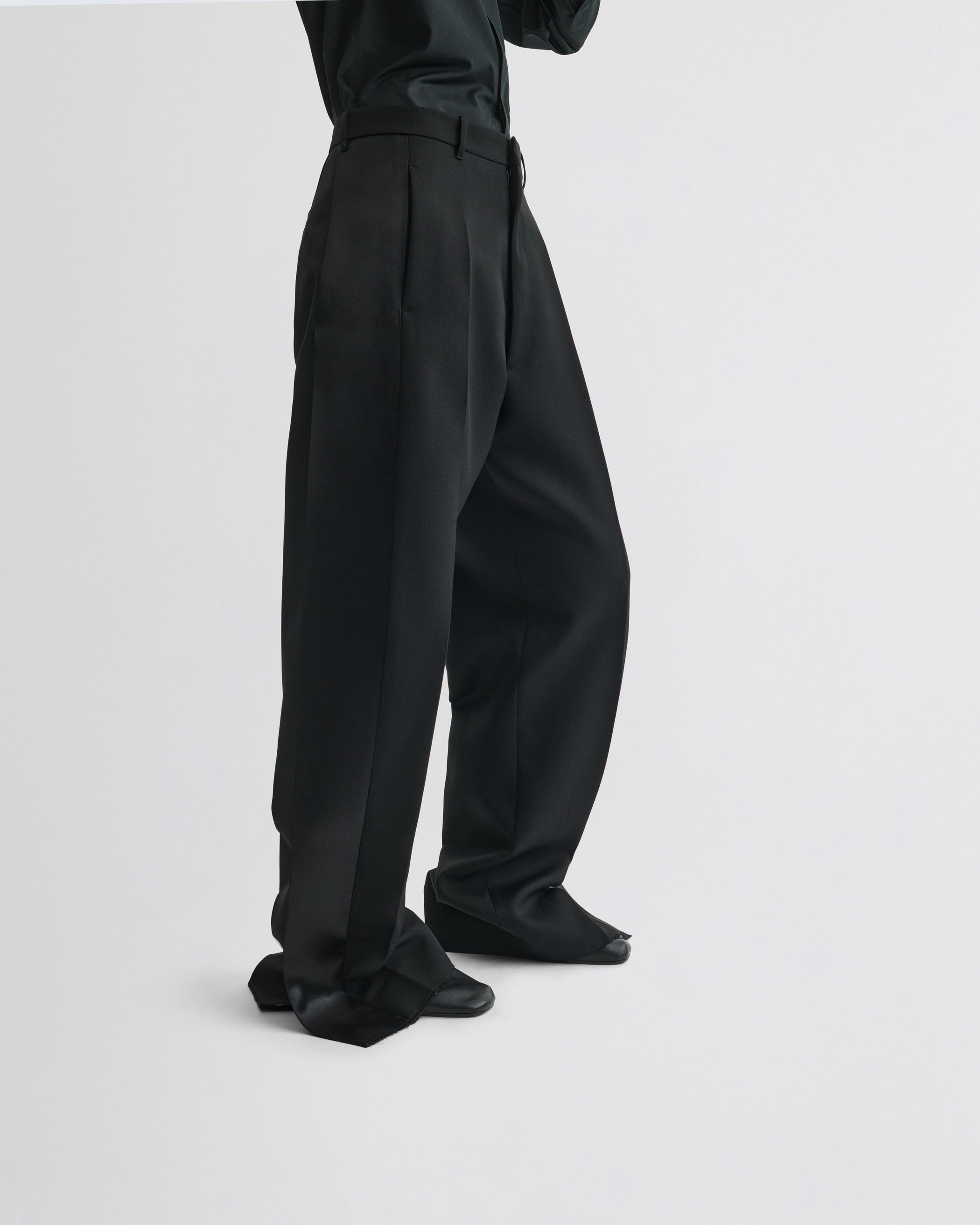 View of split tux trousers in black wool