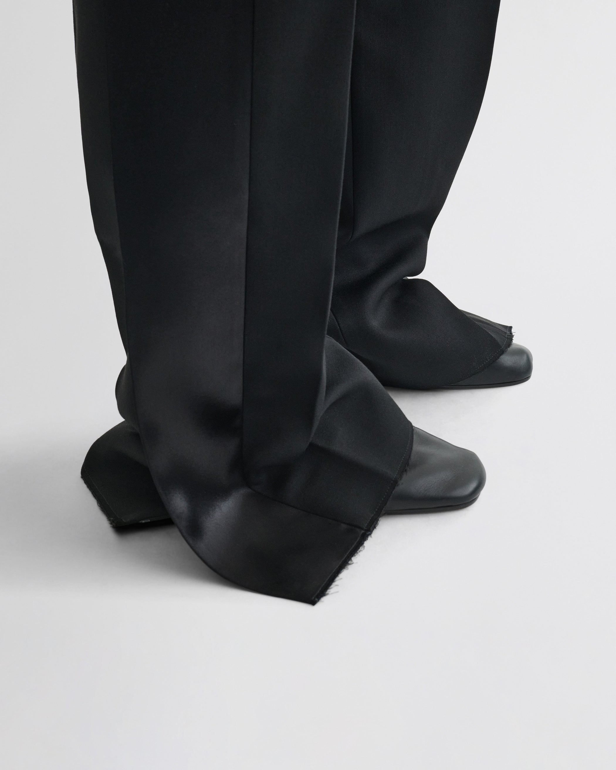 View of split tux trousers in black wool
