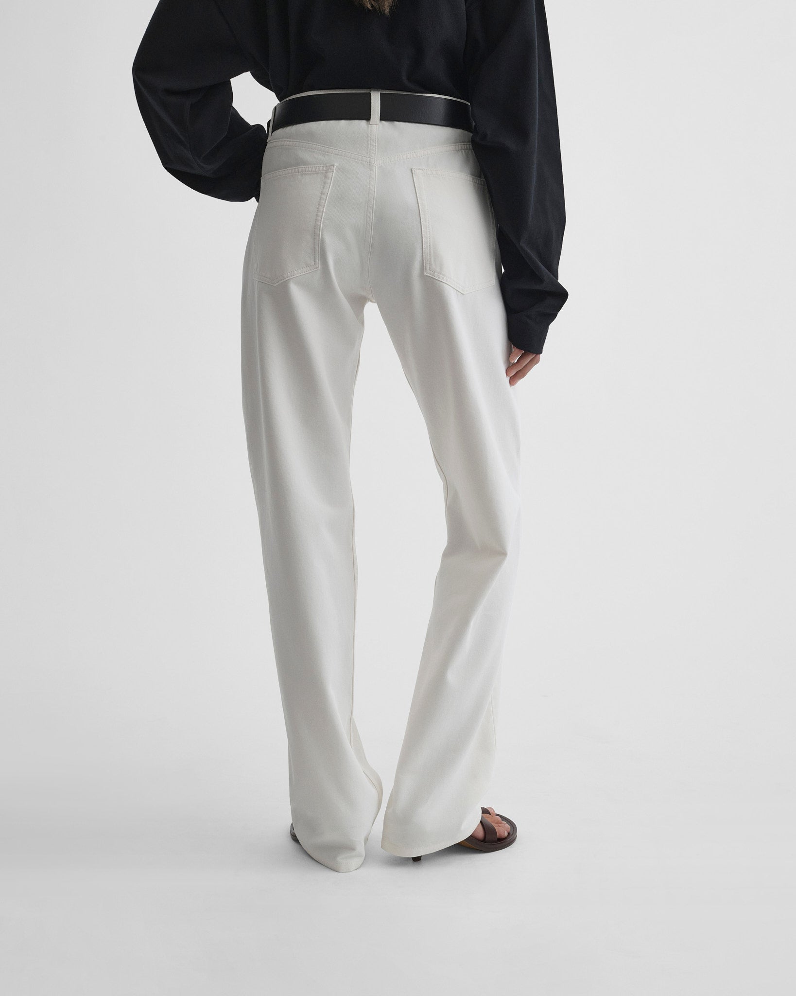 Back view of model wearing classic jeans in plaster white.