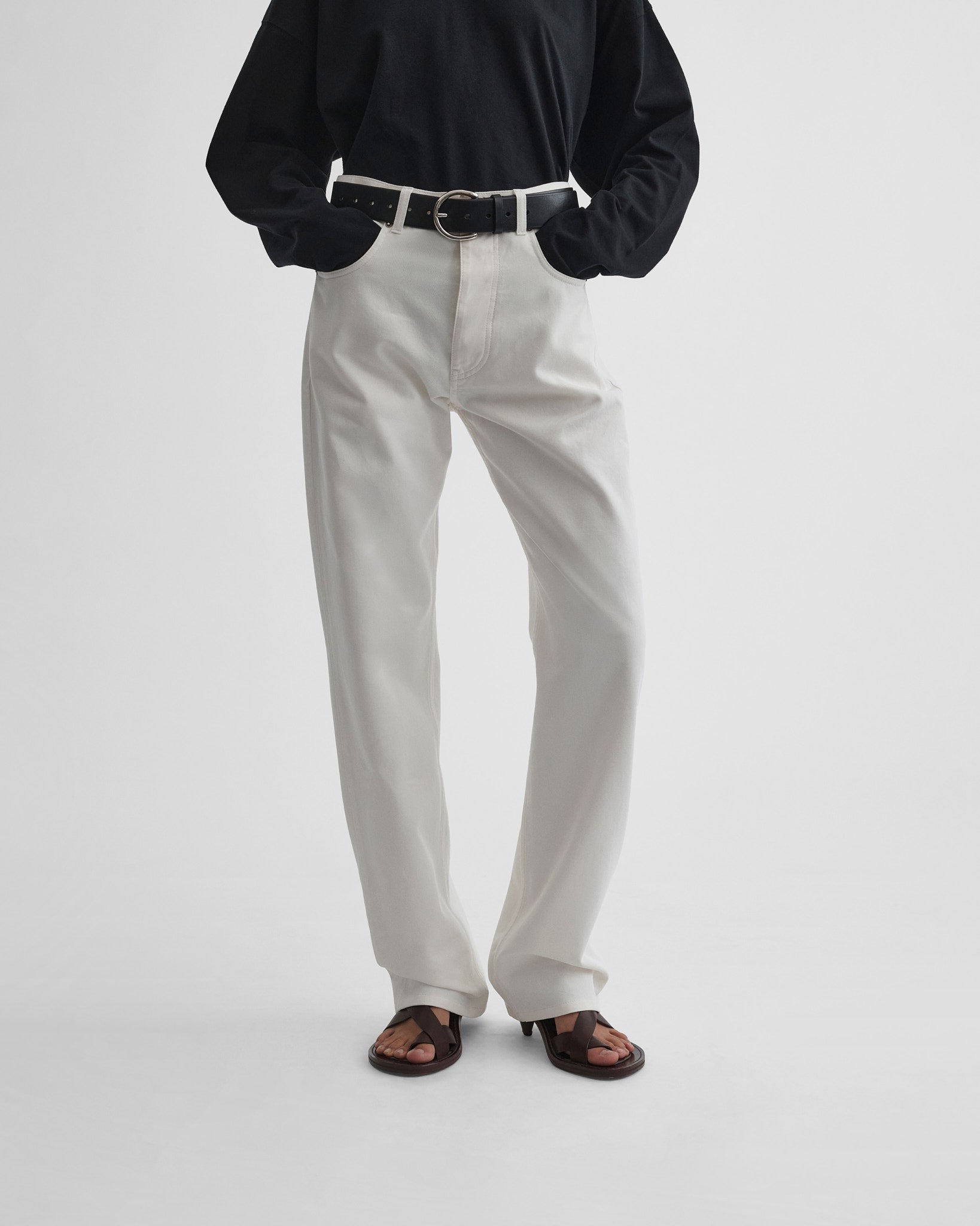 Front view of model wearing classic jeans in plaster white.