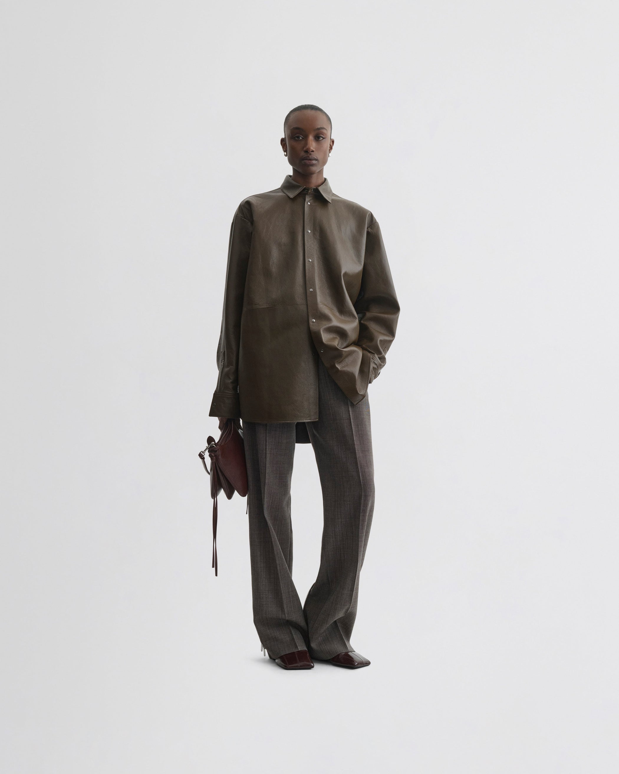 View of split zip trousers in dark brown mélange wool