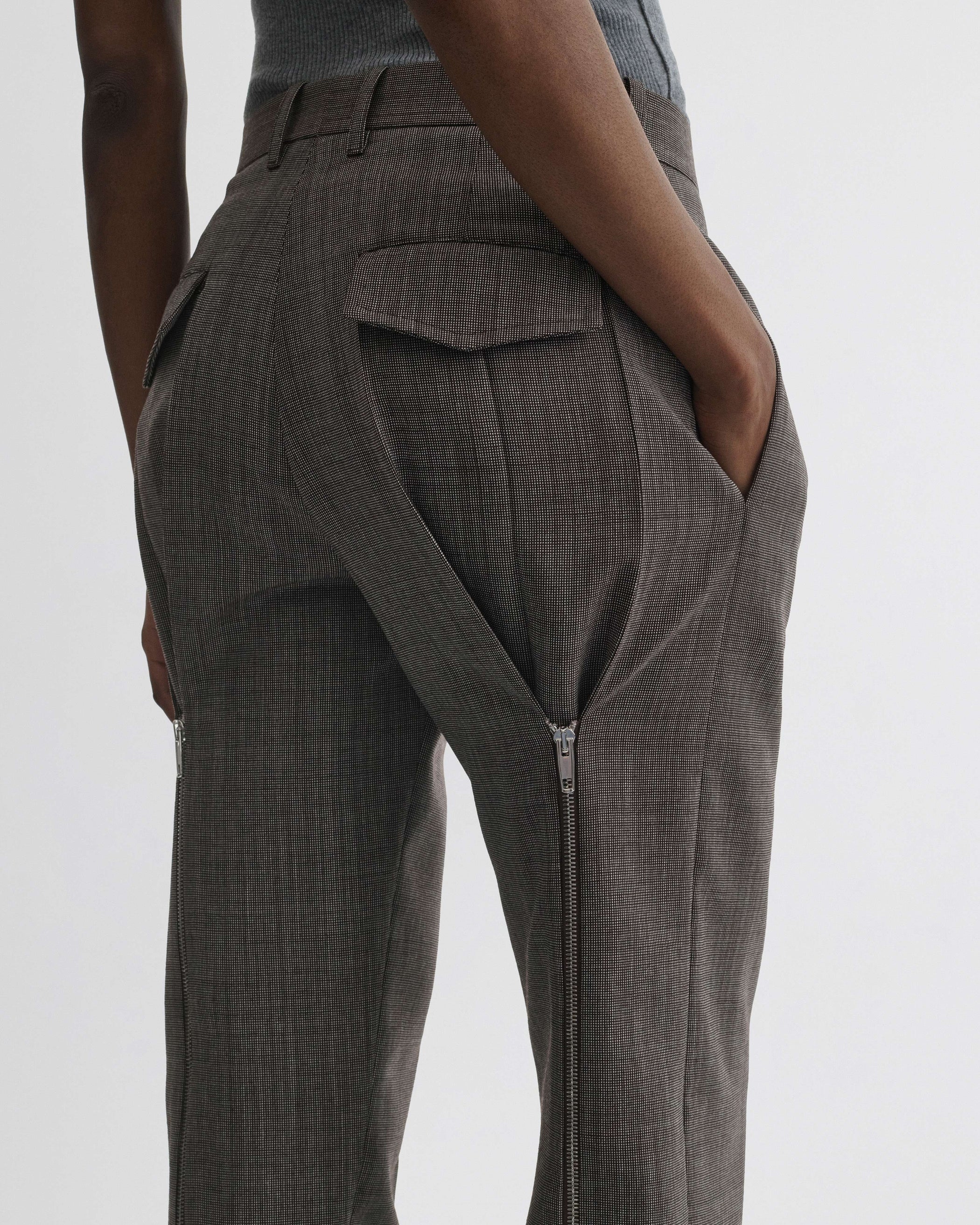 View of split zip trousers in dark brown mélange wool