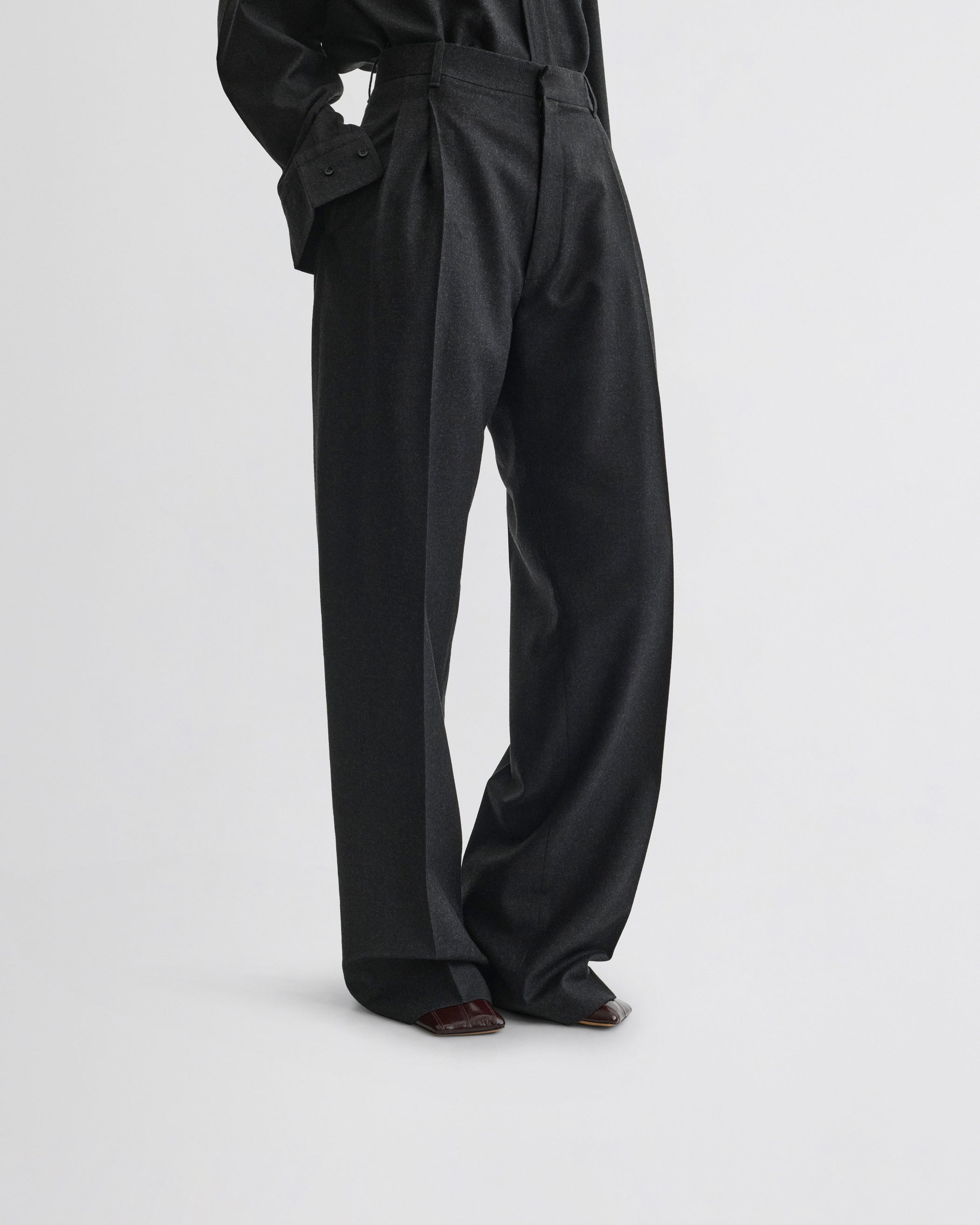 View of double pleat trousers in charcoal wool