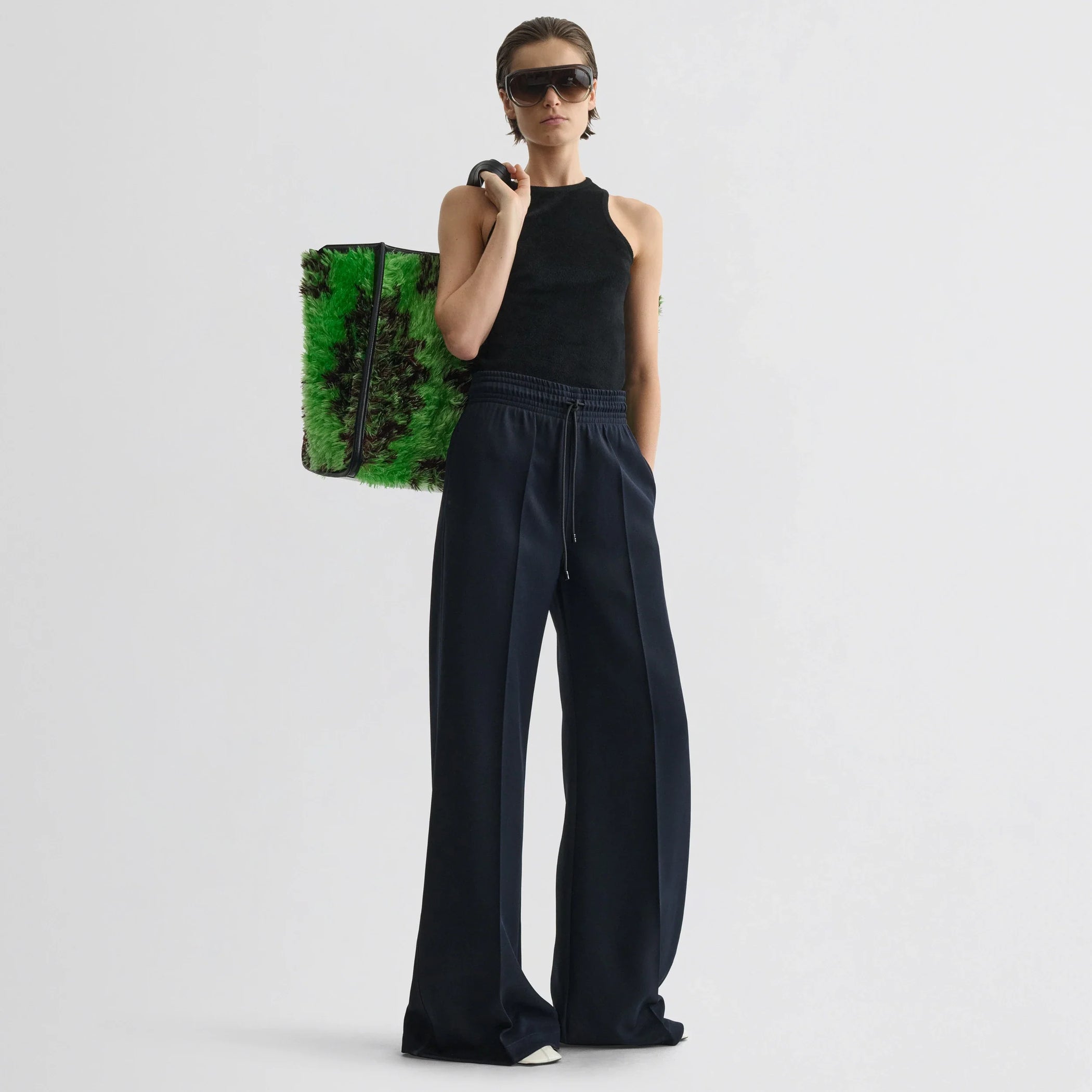Front view of model wearing track trousers in navy polyester.