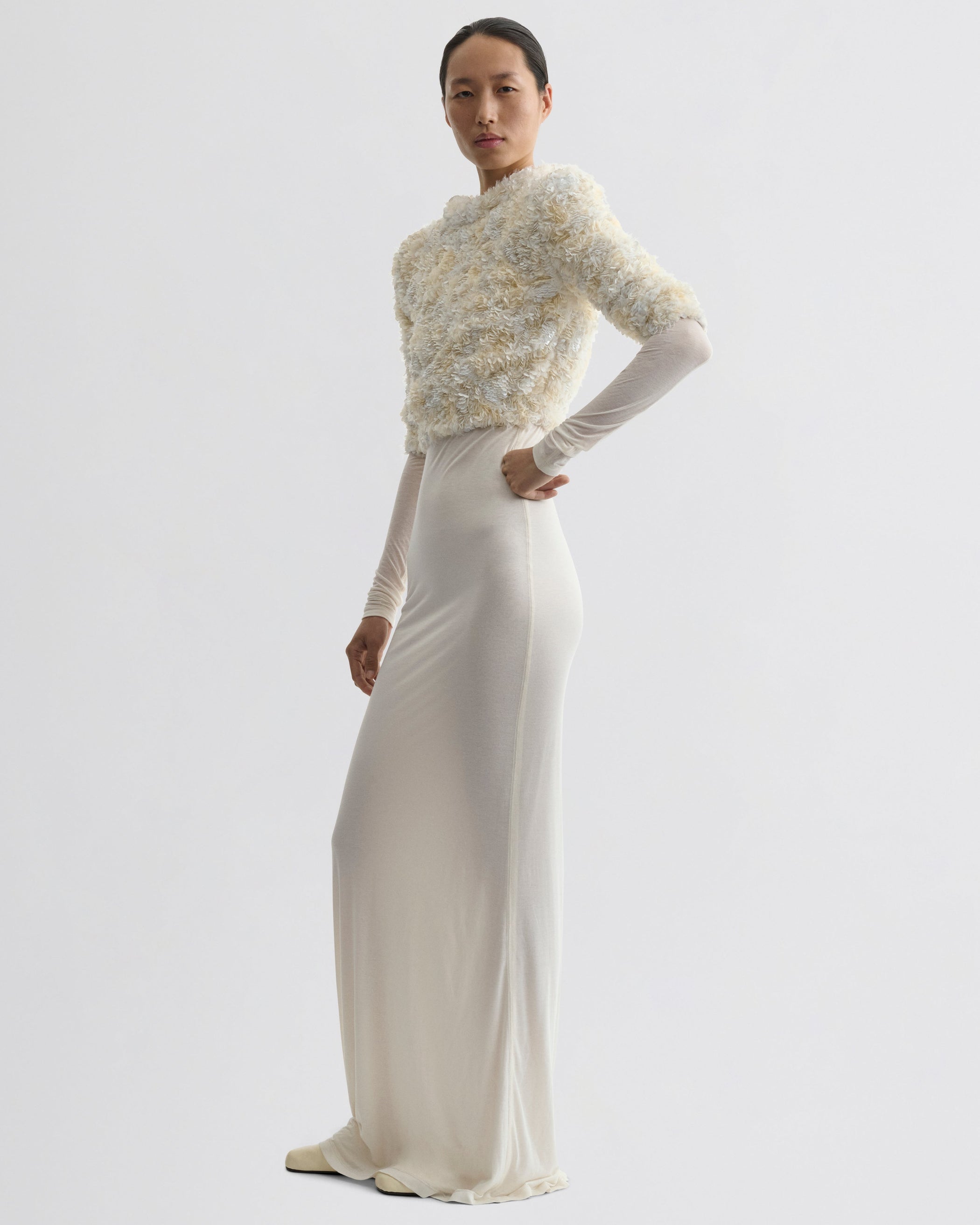 Side view of model wearing CLUSTERED SEQUIN DRESS in ivory jersey