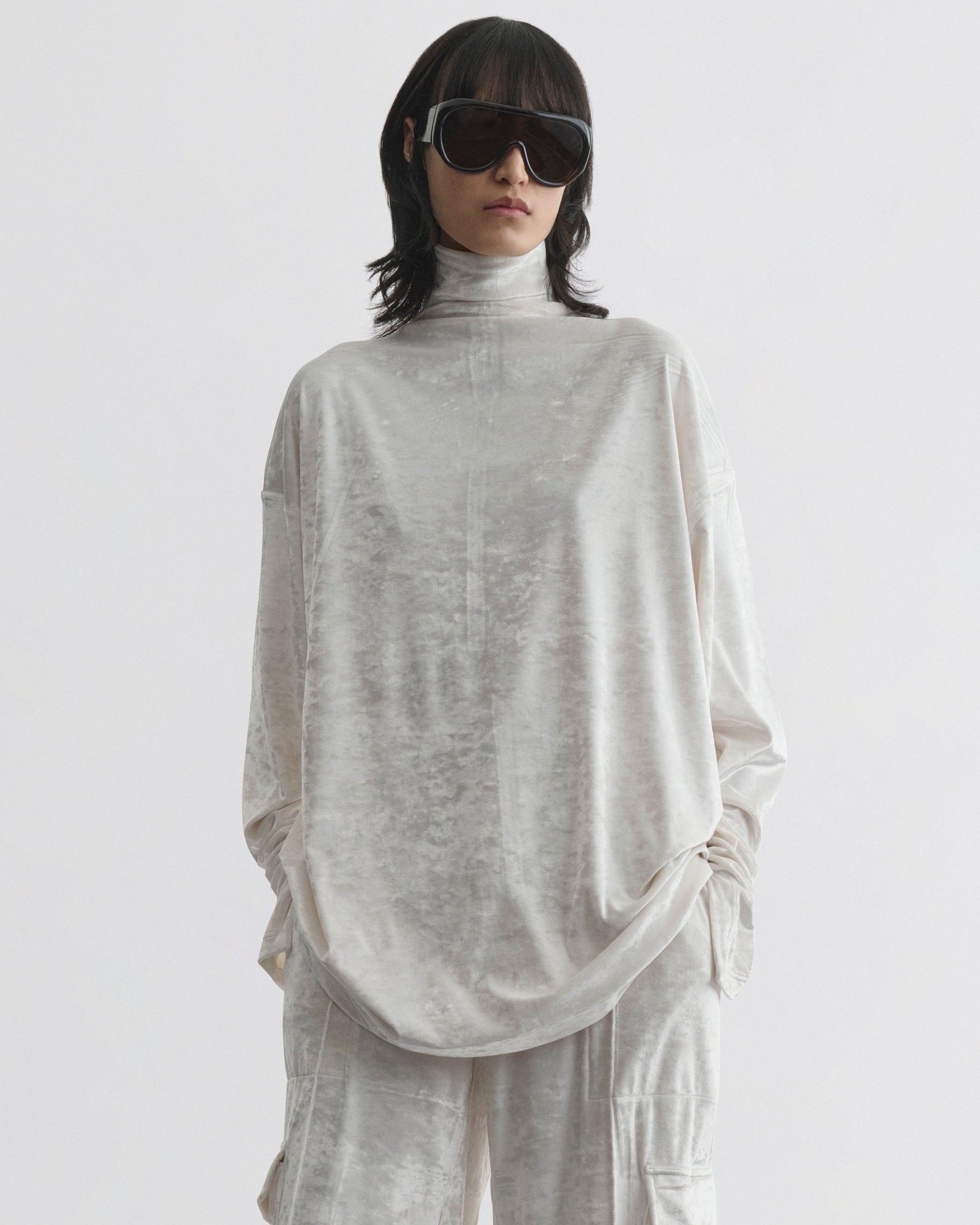 Front view of model wearing LIQUID HIGH NECK TOP in white crushed velvet