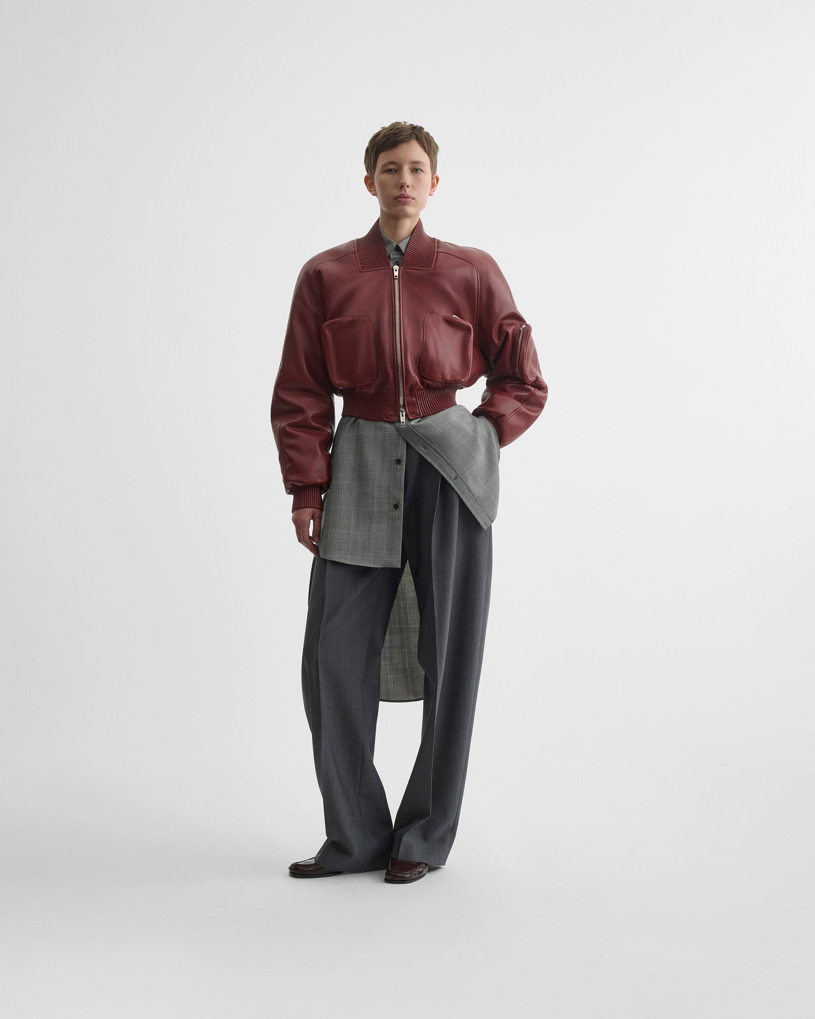 Front view of model wearing pocket bomber jacket in brick leather