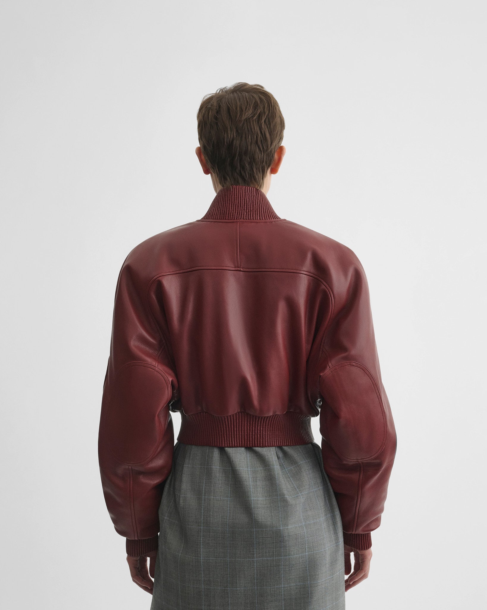 Back view of pocket bomber jacket in brick leather