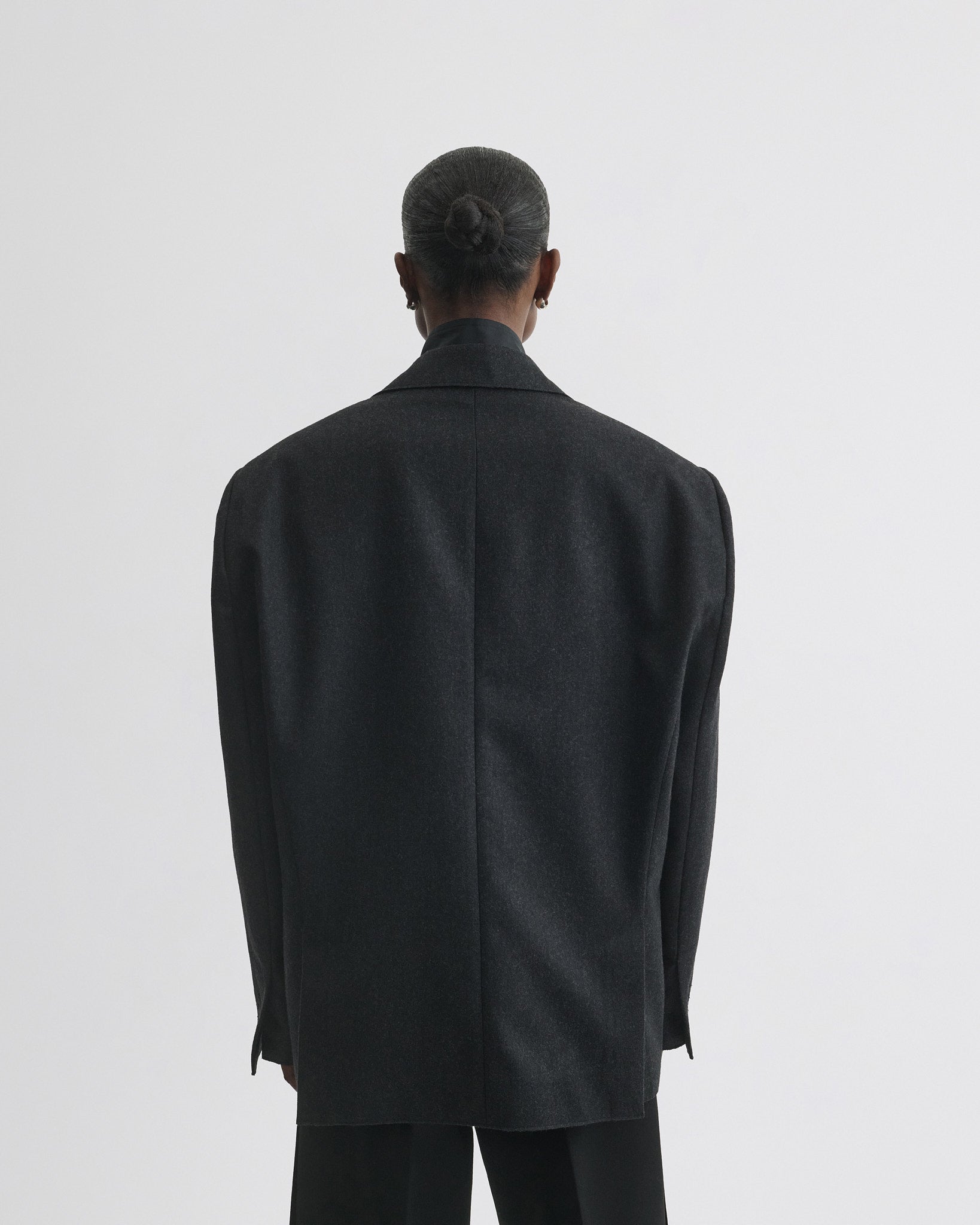 Back view of model wearing Tuxedo Jacket in anthracite wool