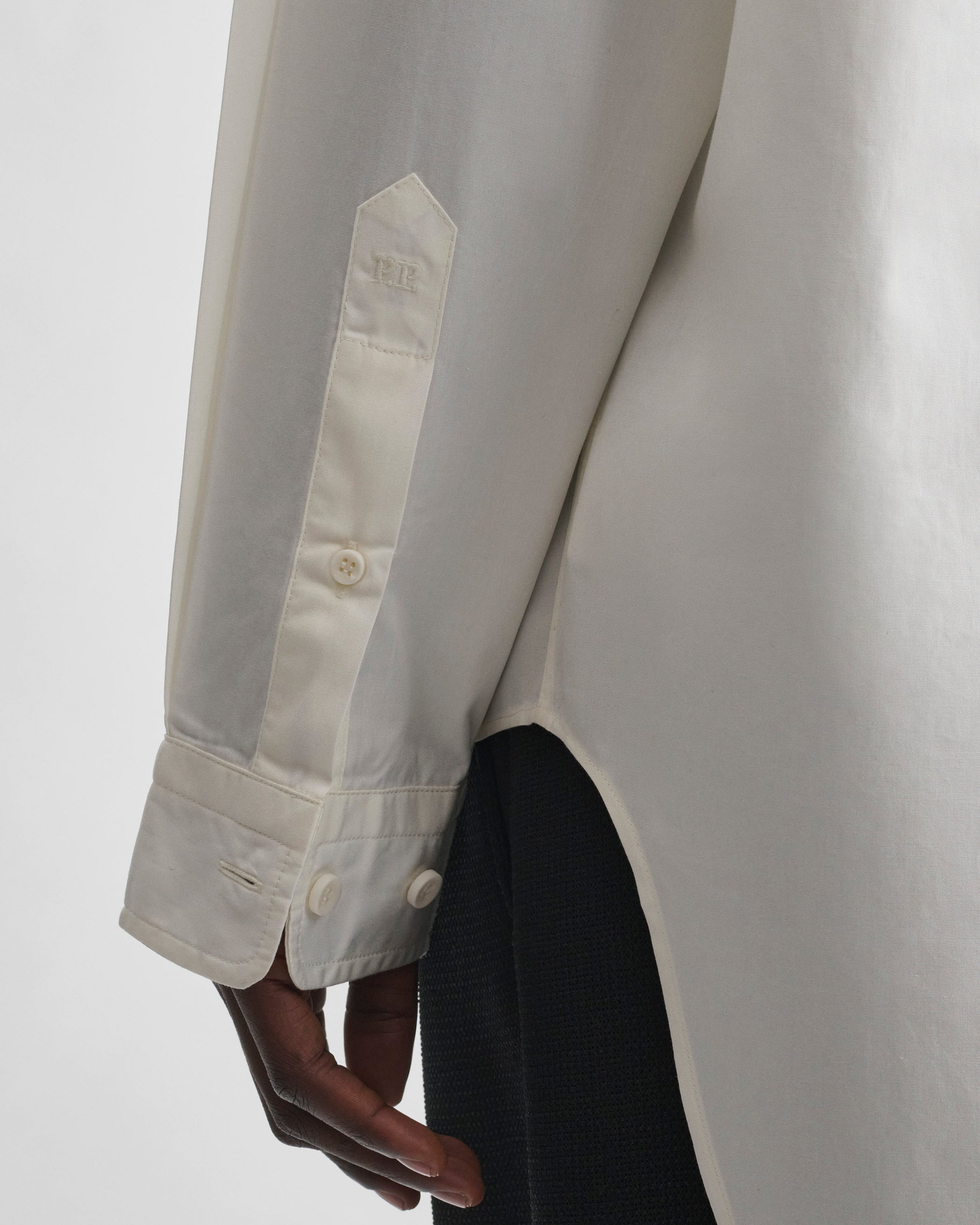Detail view of model wearing CLASSIC SHIRT in cream cotton