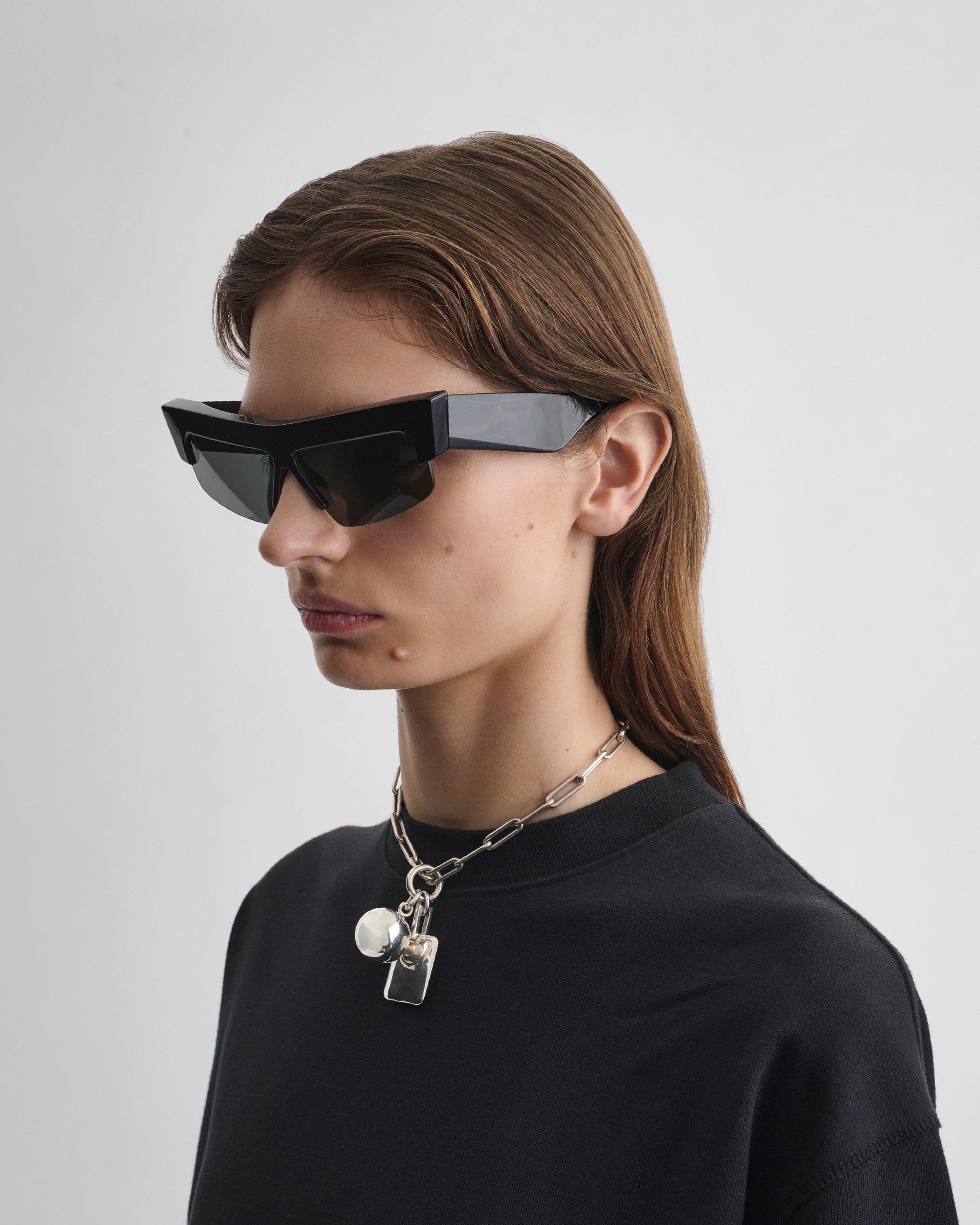 Side view of model wearing SLICED CRUISE in black acetate