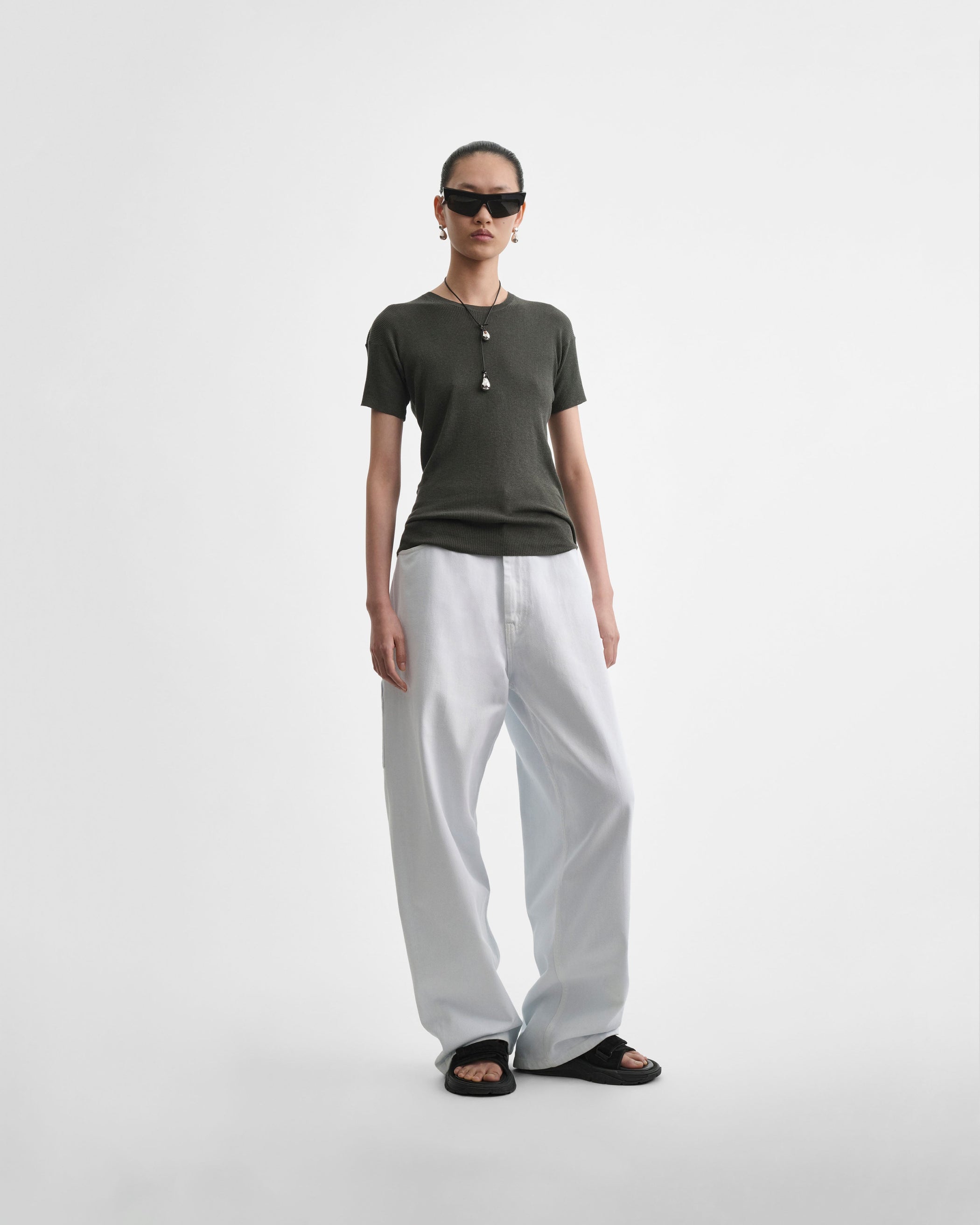 Full length front view of model wearing RELAXED ZIP JEANS in pale ice blue cotton